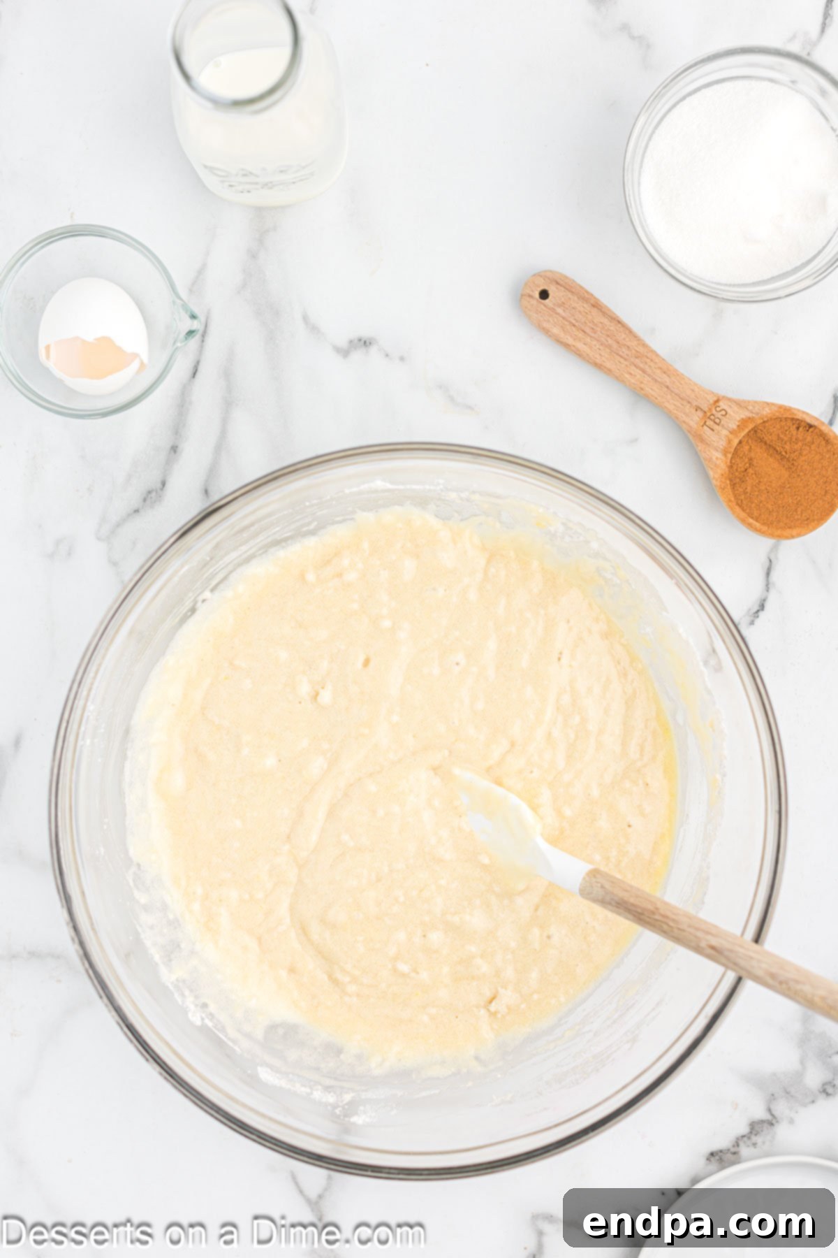 Wet ingredients being combined with dry ingredients in a bowl. 