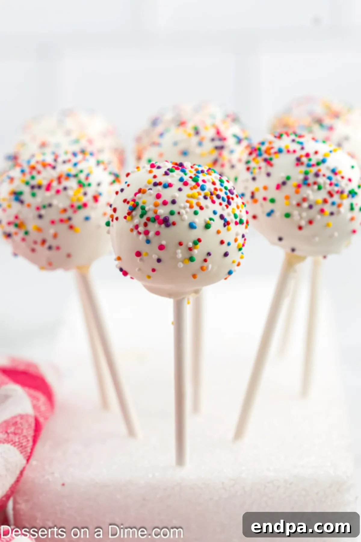 Whip Up Perfect Cake Pops 2 Vibrant cake pops in a white styrofoam block, ready for serving.