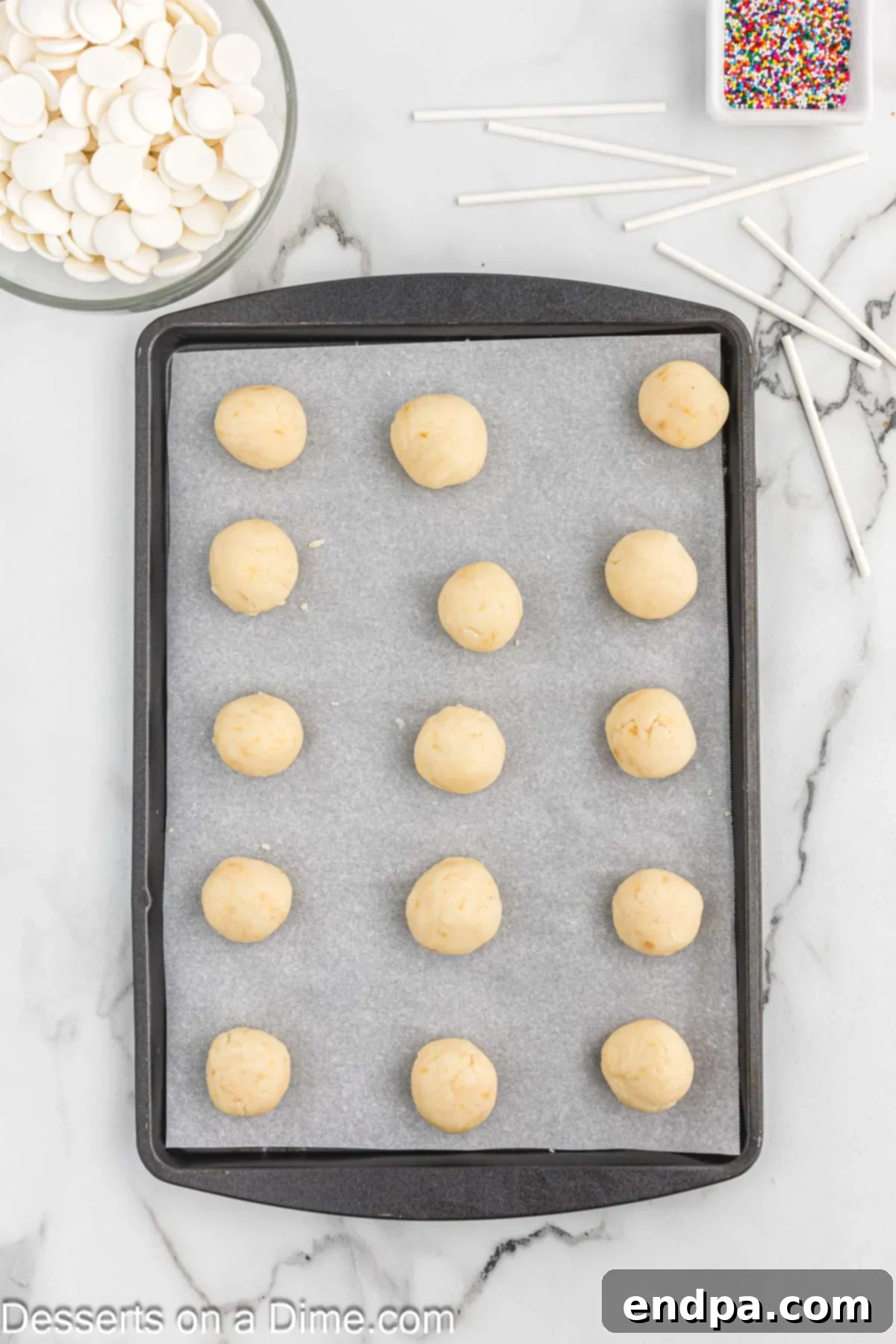 Whip Up Perfect Cake Pops 6 Uniform cake balls arranged on a parchment-lined baking sheet.
