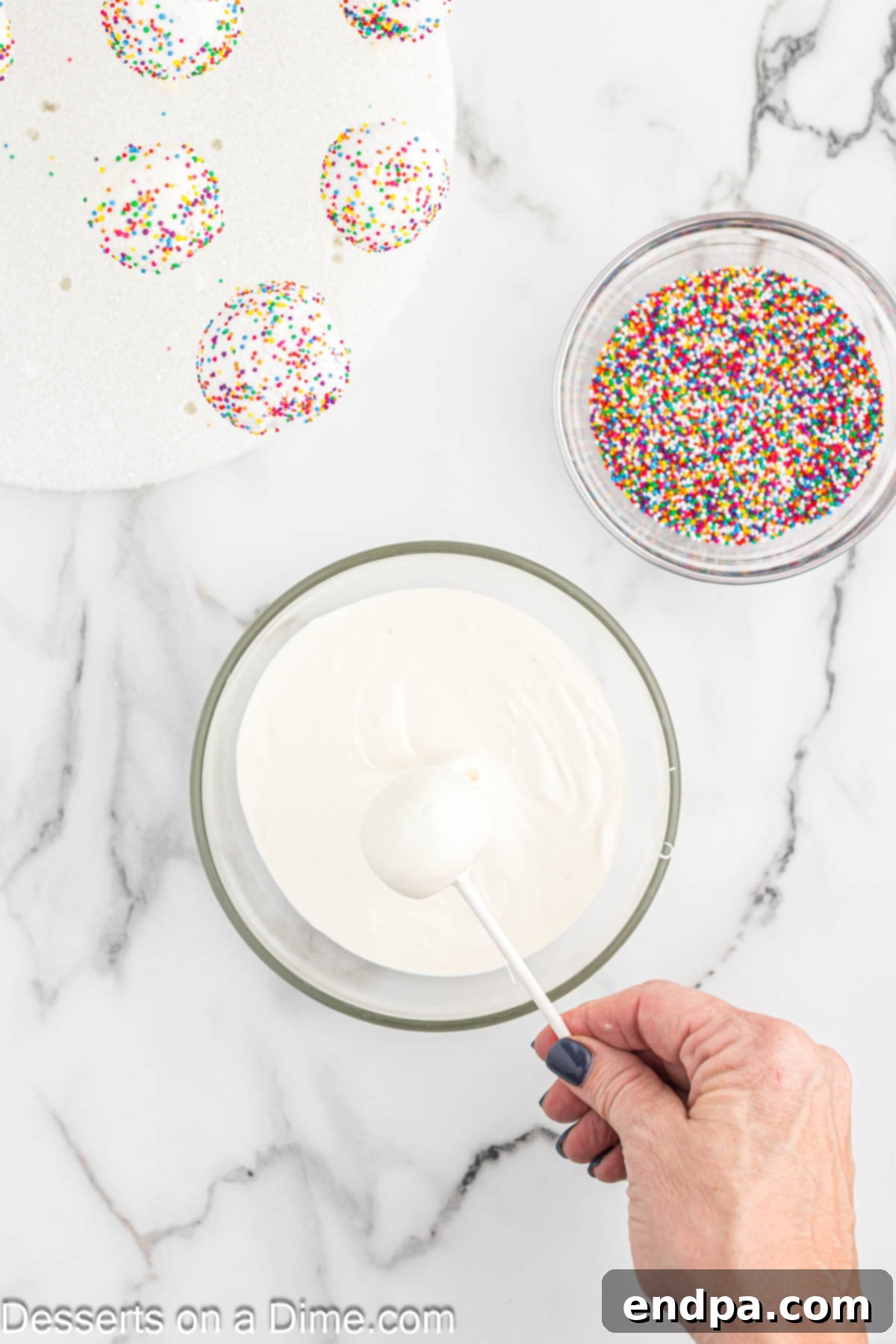 Whip Up Perfect Cake Pops 9 A cake pop being dipped into a bowl of melted candy melts for a smooth coating.