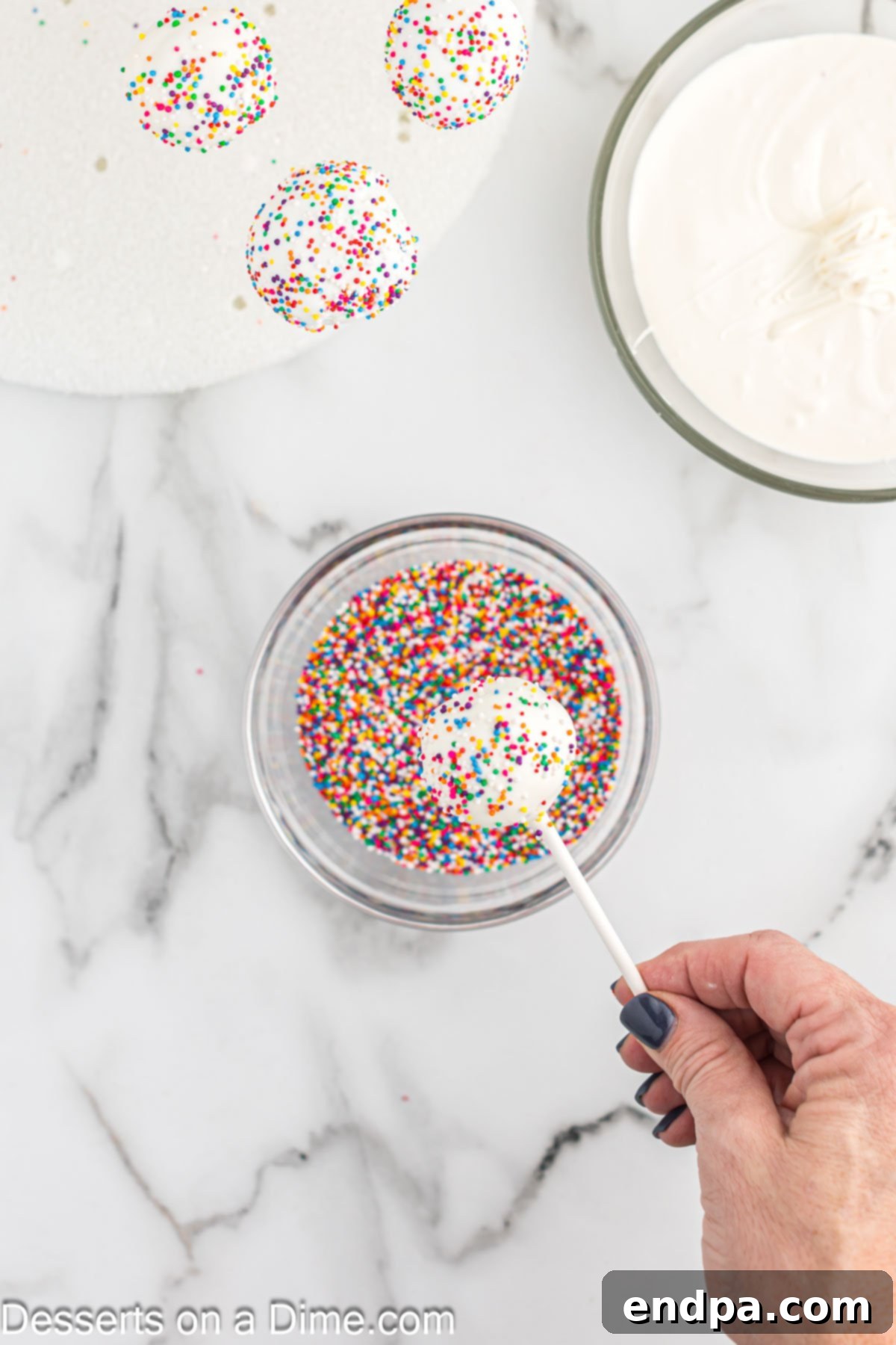 Whip Up Perfect Cake Pops 10 A cake pop being decorated with sprinkles immediately after dipping in candy melts.