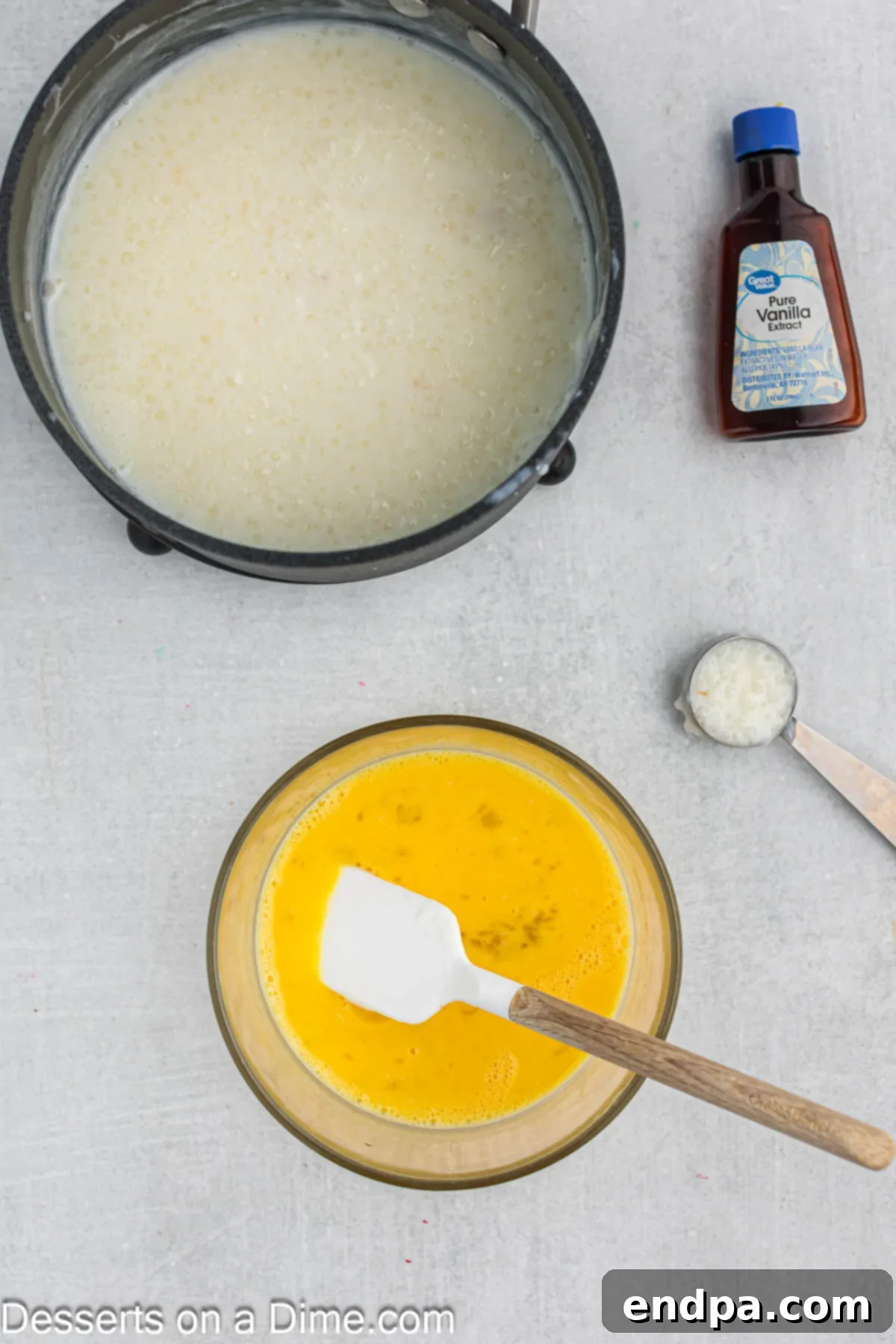 Two large eggs, freshly beaten, in a small separate bowl, ready for tempering.