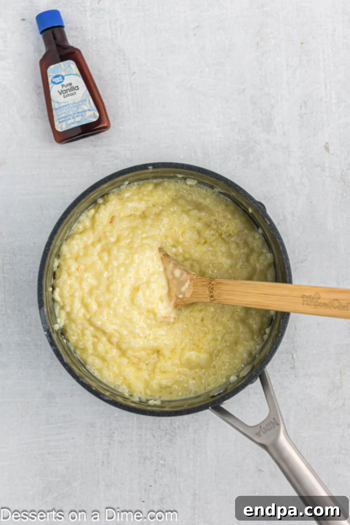 The tapioca pudding mixture in the saucepan, with the tempered eggs slowly being incorporated.