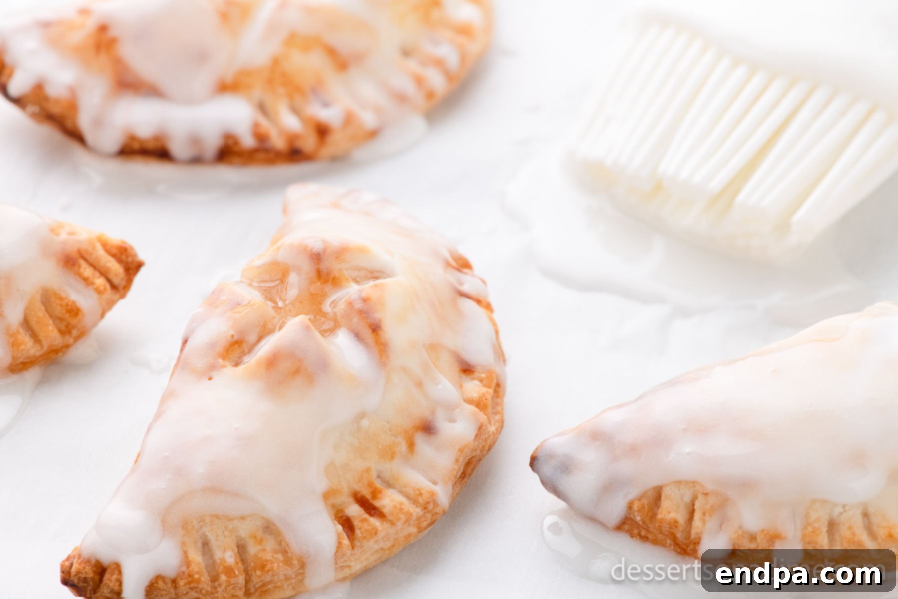 Delicious golden Air Fryer Hand Pies topped with a sweet glaze, ready to be enjoyed.