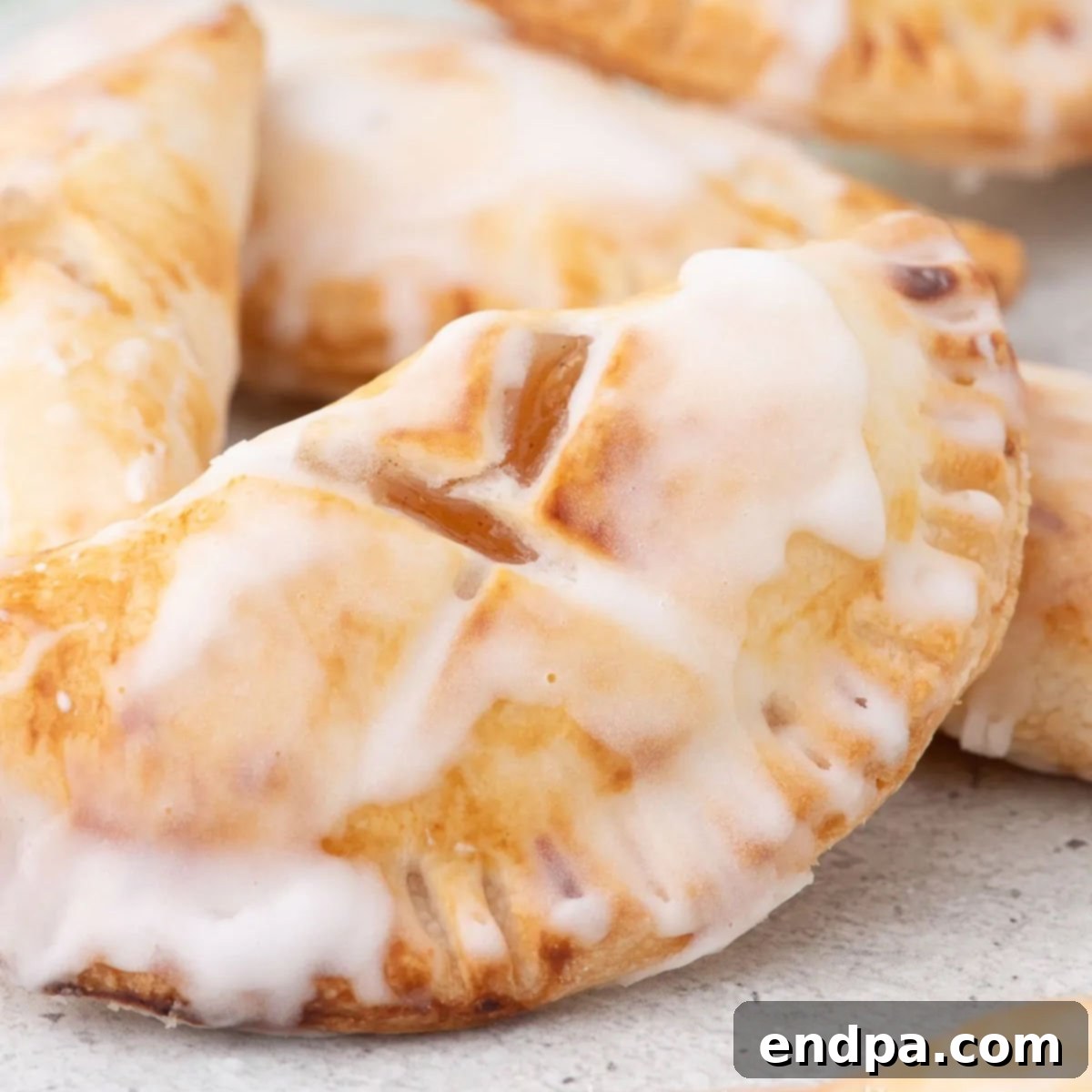 Air Fryer hand pies ready to enjoy and topped with glaze.