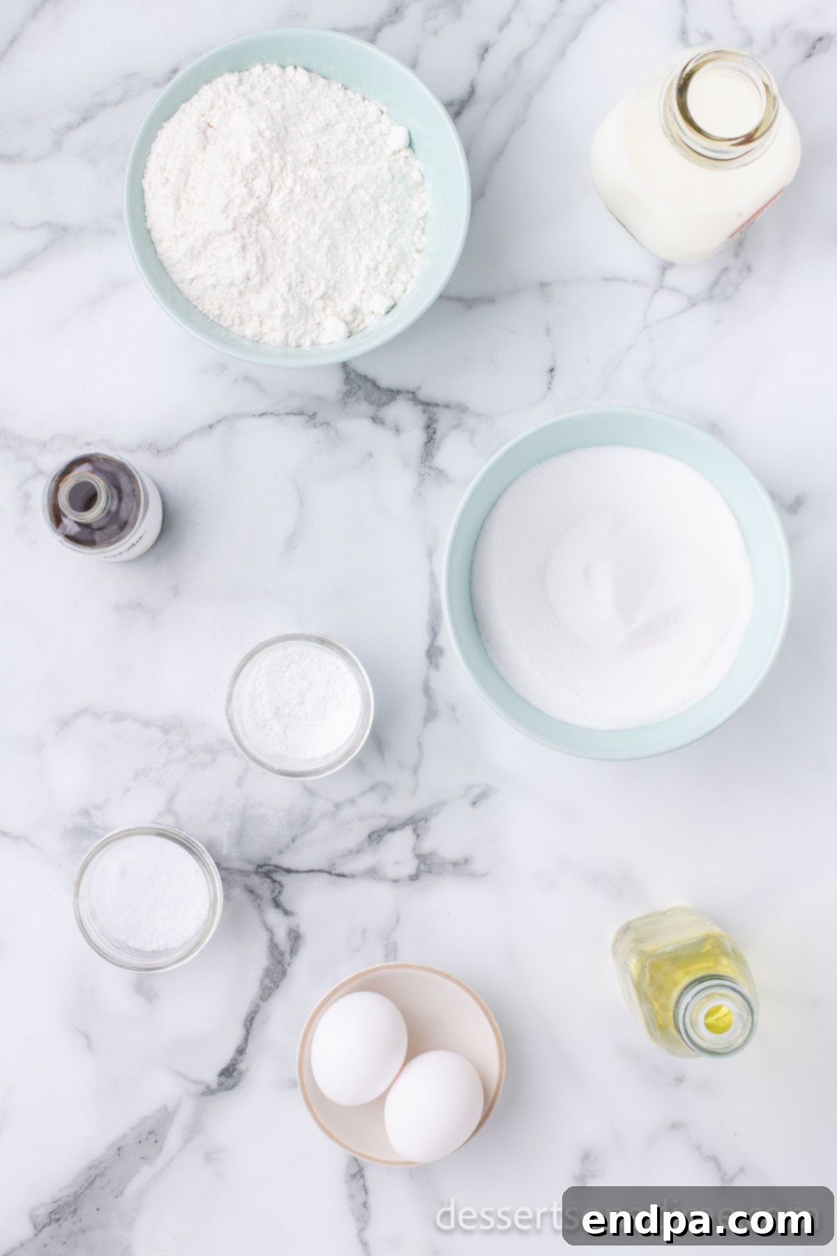 A selection of essential ingredients for sweet bread, including all-purpose flour, granulated sugar, whole milk, vanilla extract, baking powder, salt, large eggs, and vegetable oil, neatly arranged on a counter.