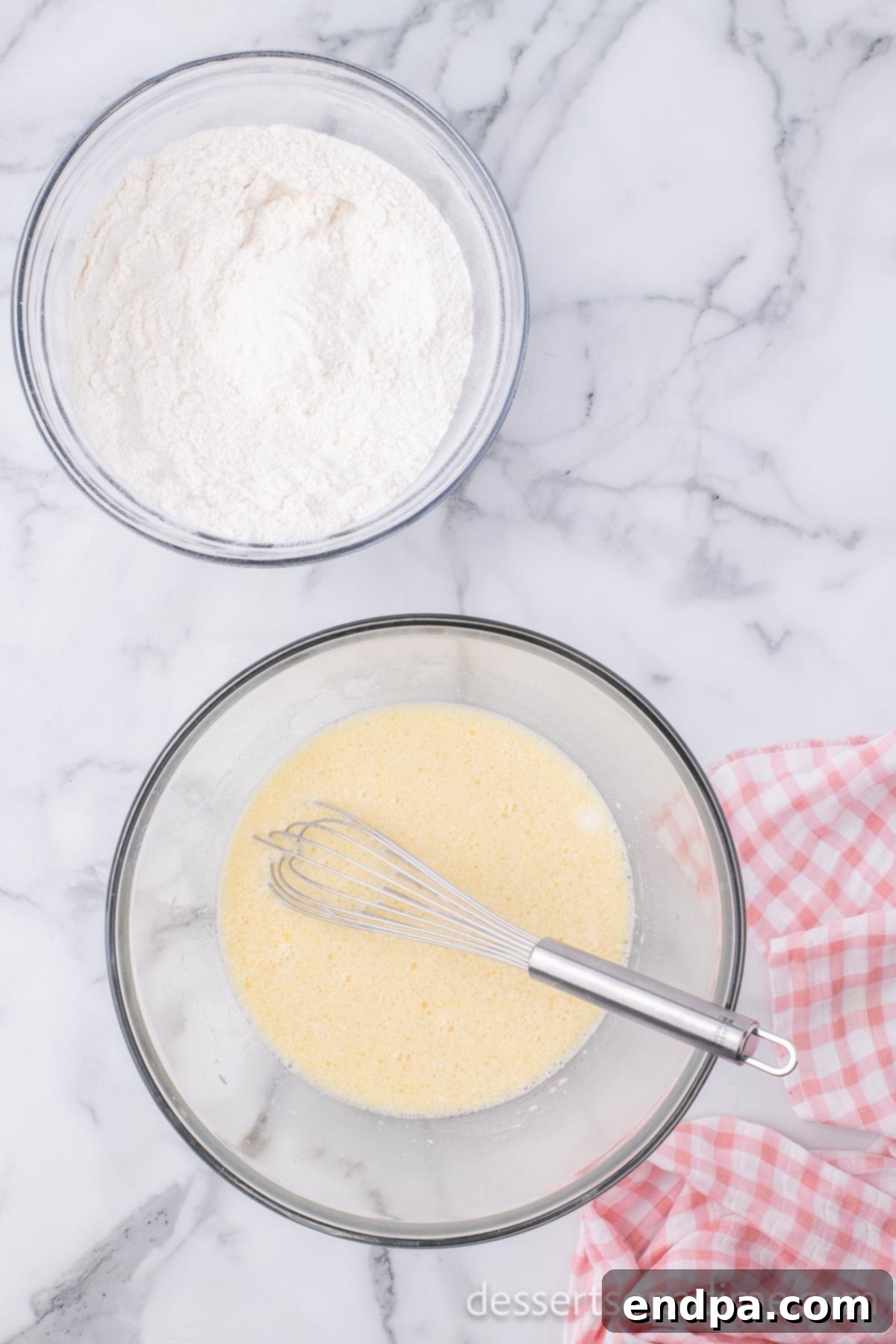 Separate small mixing bowl containing the wet ingredients: whole milk, vanilla extract, large eggs, and vegetable oil, whisked until smooth and well combined.