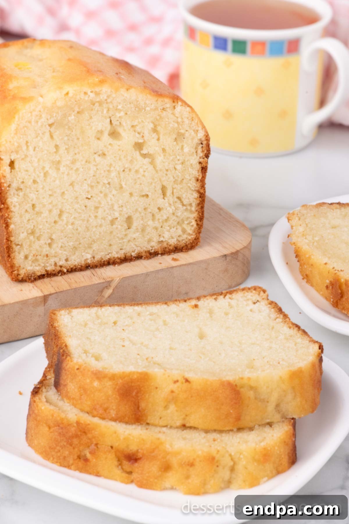 A delightful Sweet Bread loaf with several slices expertly cut, clearly showcasing its moist interior and inviting golden crust, inviting immediate enjoyment.