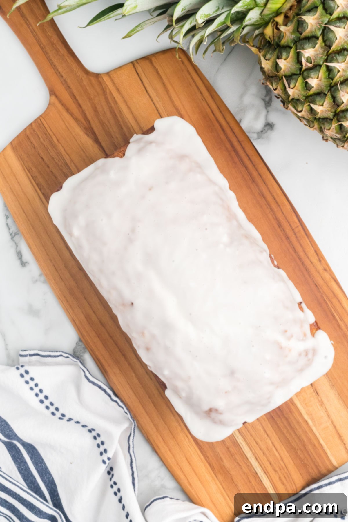 Grilled Pineapple Sweetbread 15 Loaf of bread with glaze on board.