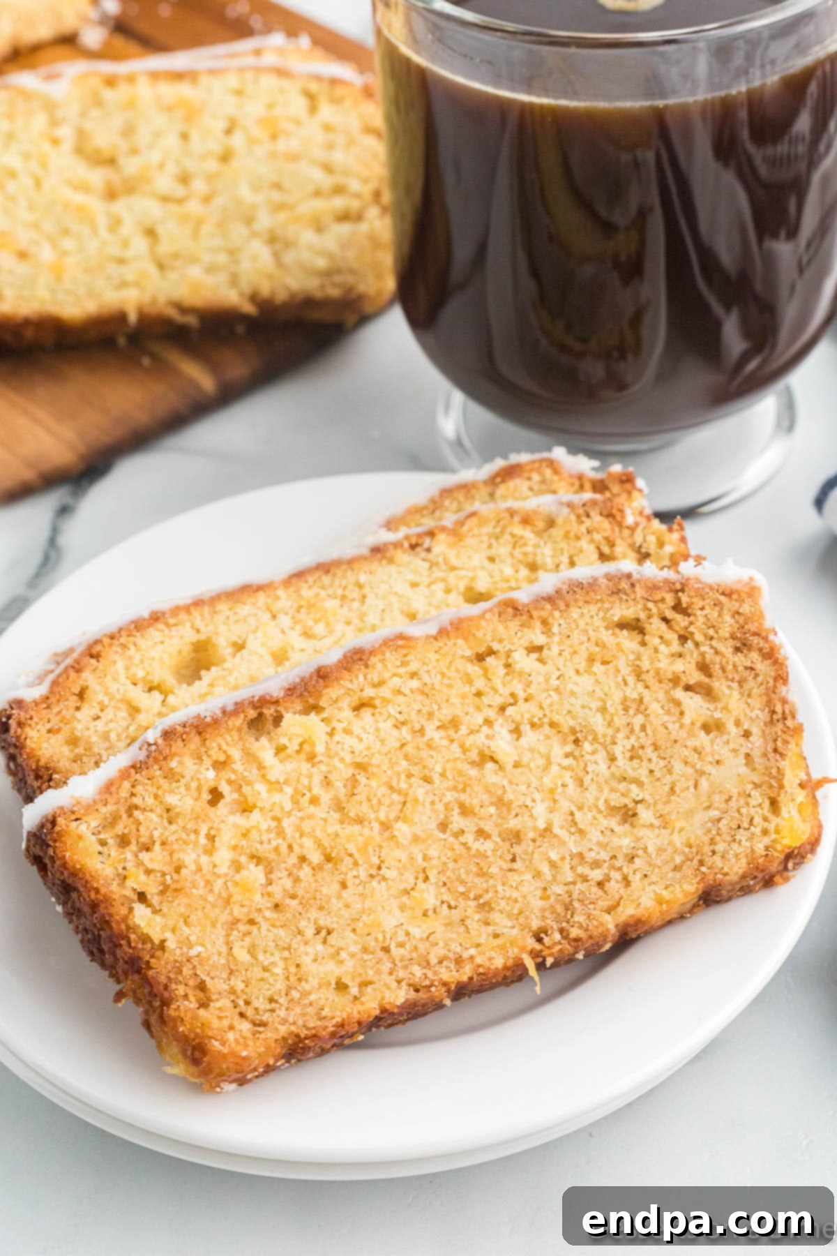 Grilled Pineapple Sweetbread 16 Slices of bread on a plate beside a cup of coffee.