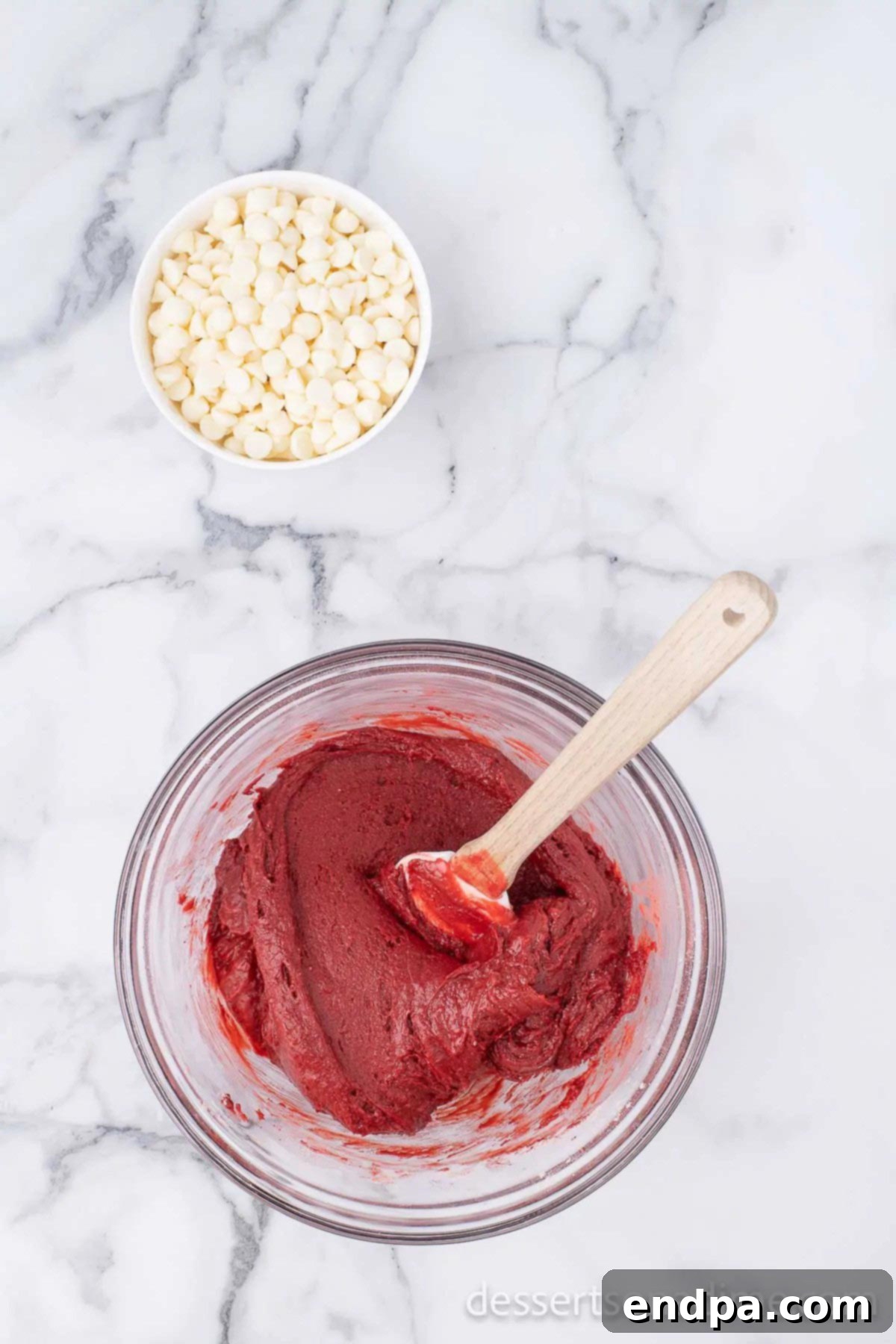 Ruby Red Brownie Bliss 5 Combining the red velvet mixture together in a bowl with a spatula, showing its thick consistency.