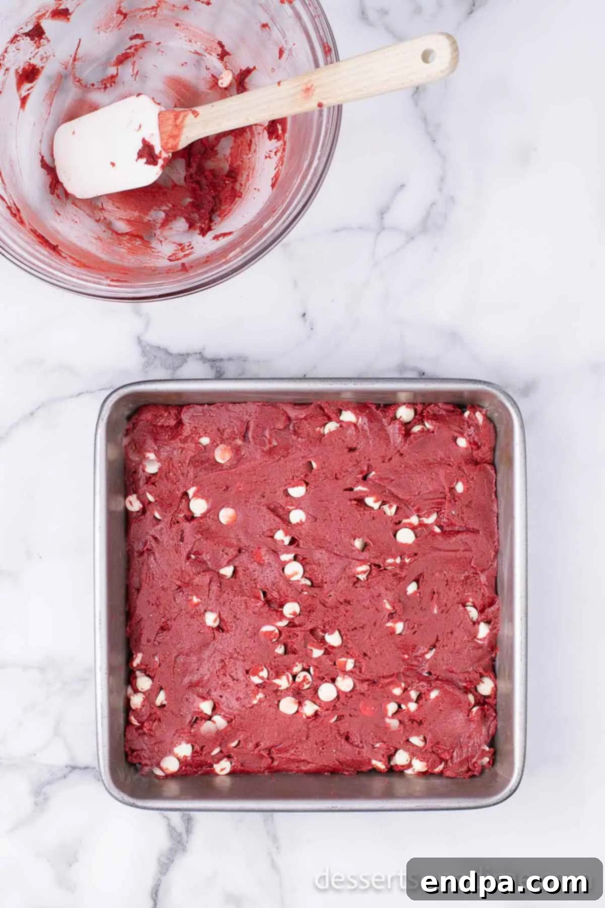 Ruby Red Brownie Bliss 6 Spreading the vibrant red brownie batter evenly into the prepared baking dish.