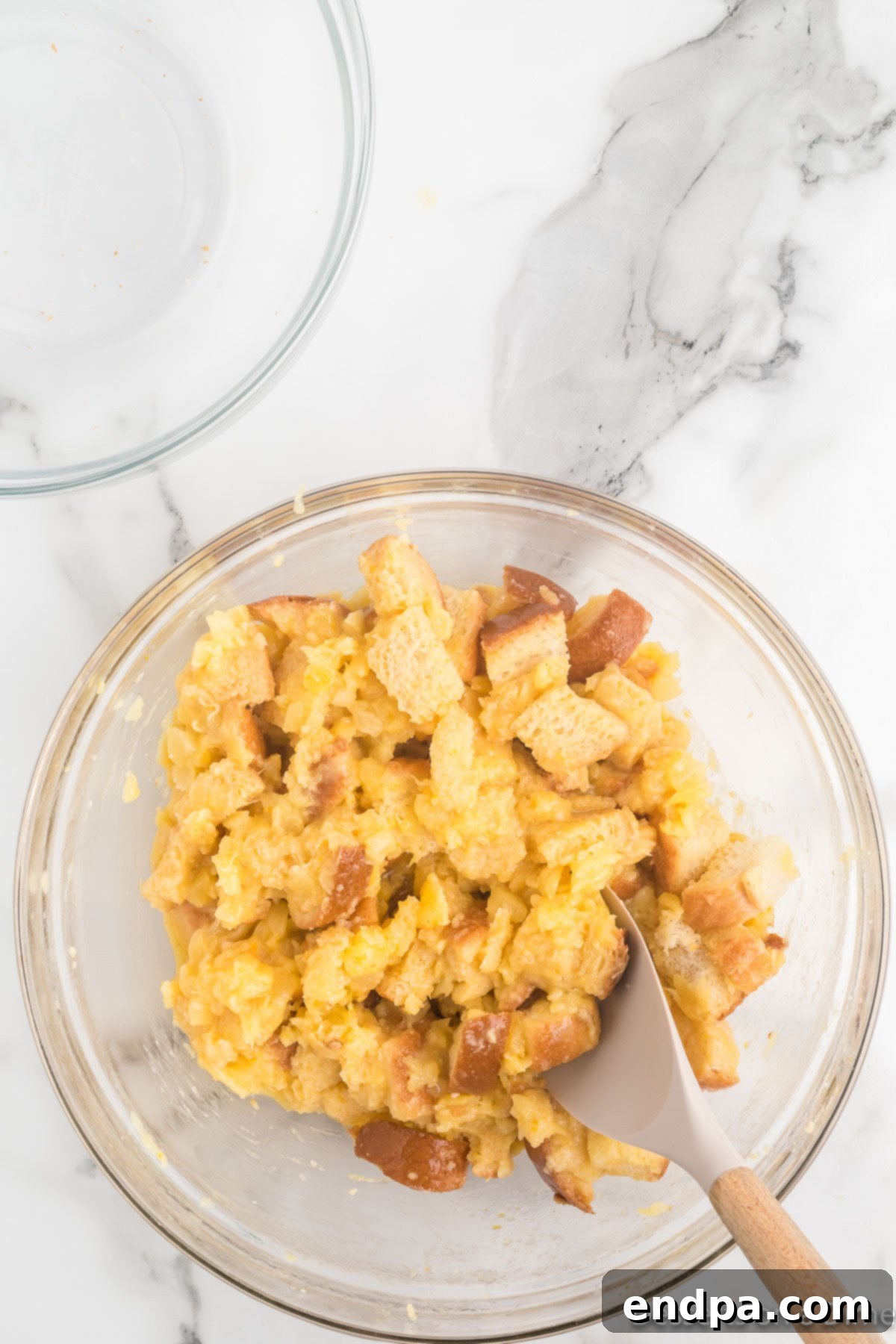 Tropical Pineapple Bread Pudding 6 Bread cubes added to bowl.