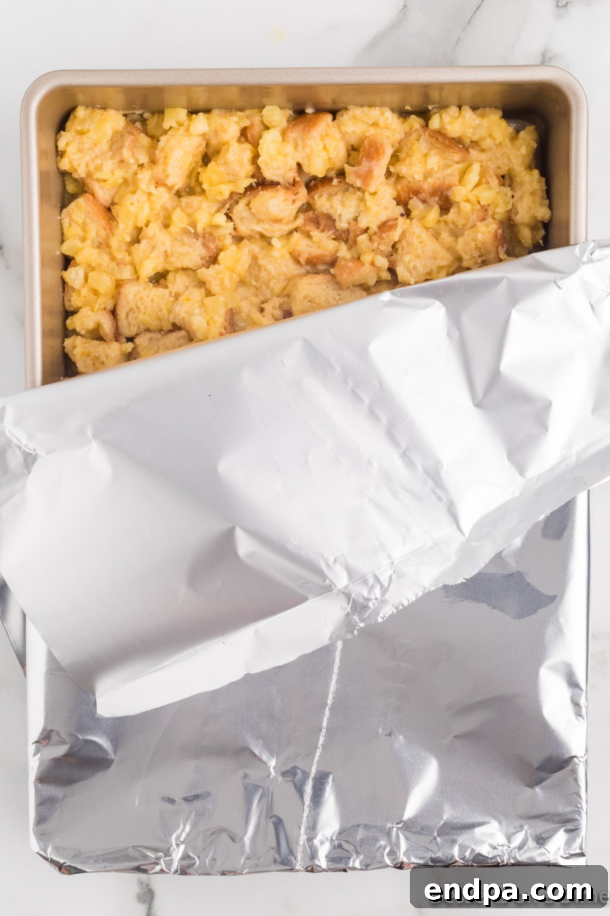 Tropical Pineapple Bread Pudding 7 Mixture in pan and covered with foil.