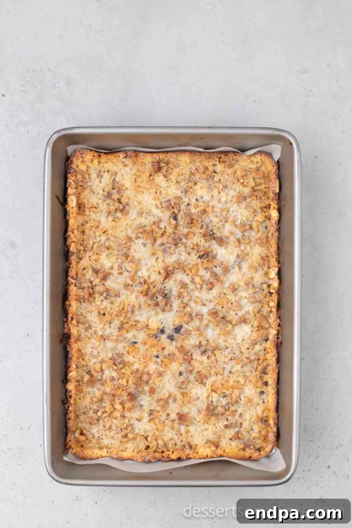 Irresistible Magic Cookie Bars Recipe 8 The baked magic bars in the pan, golden brown at the edges.