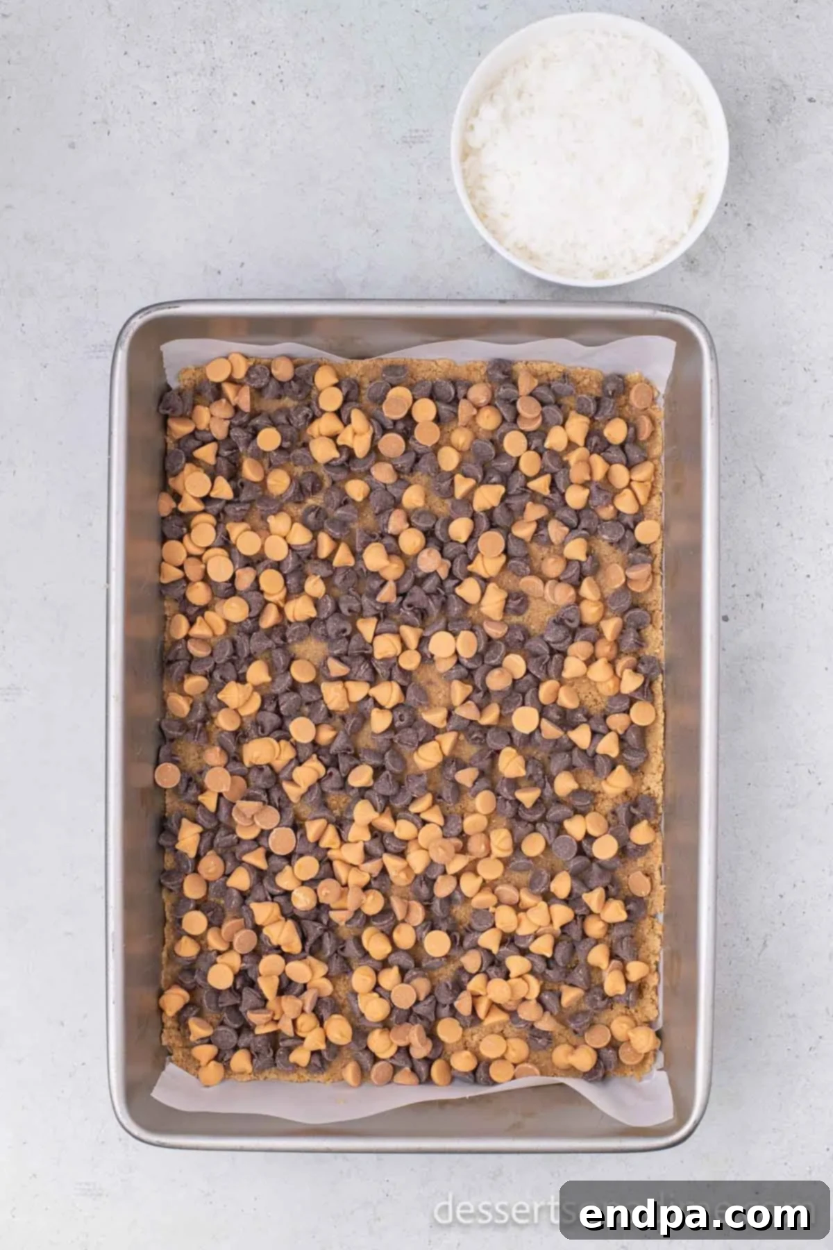Irresistible Magic Cookie Bars Recipe 5 Butterscotch chips sprinkled over the crust.