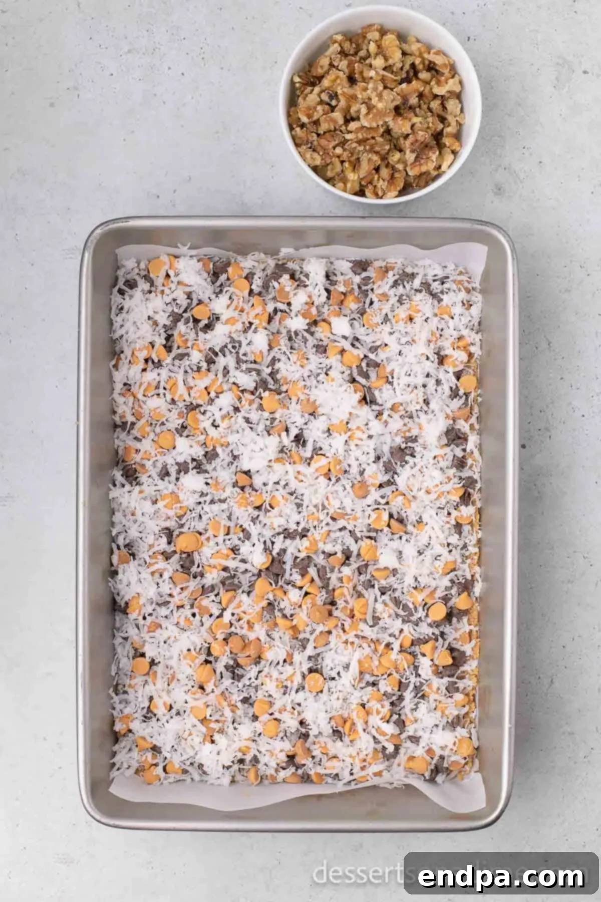 Irresistible Magic Cookie Bars Recipe 6 Coconut flakes sprinkled on top of the chips.