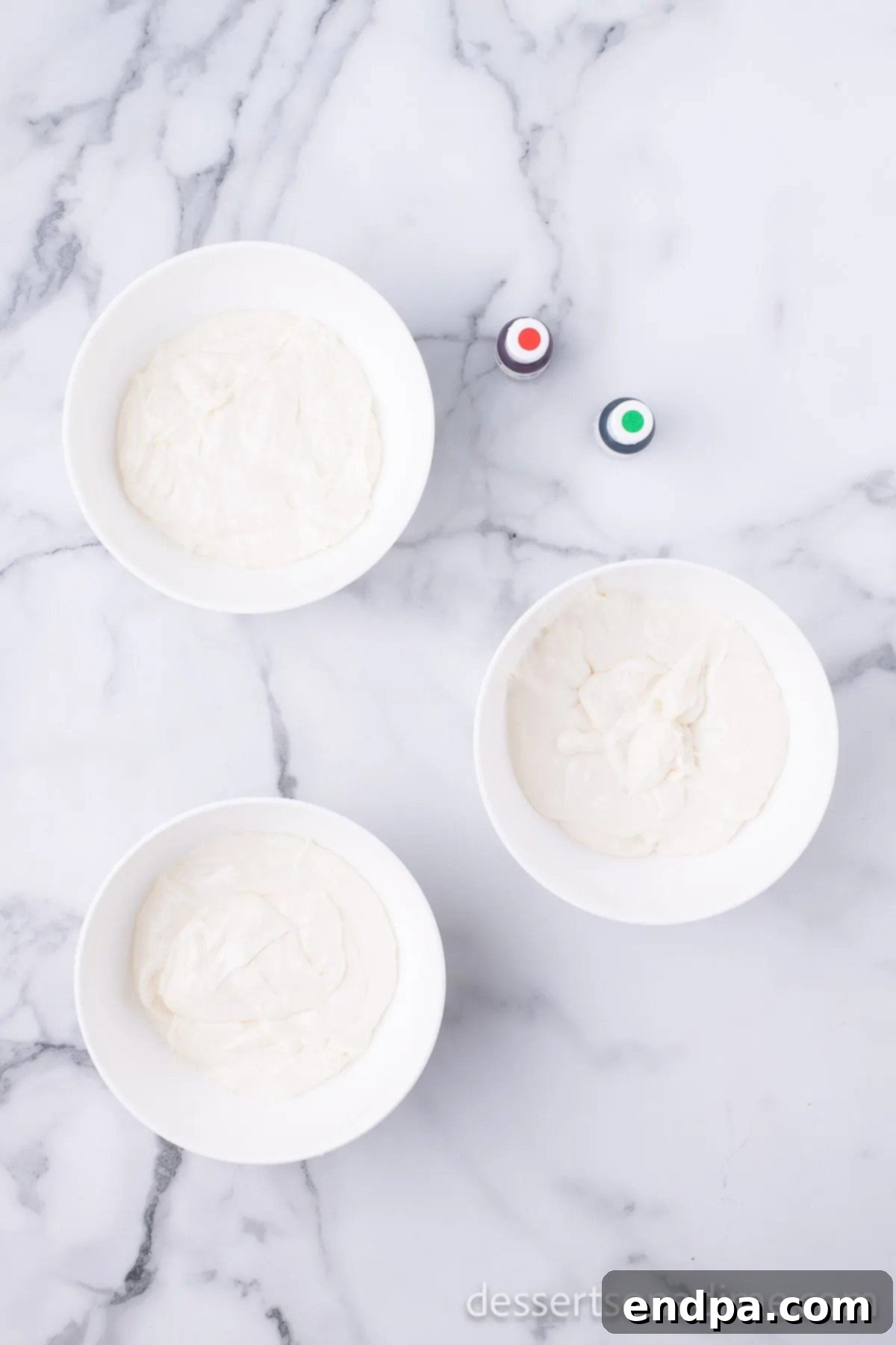 Fudge mixture separated into three bowls, preparing for coloring.