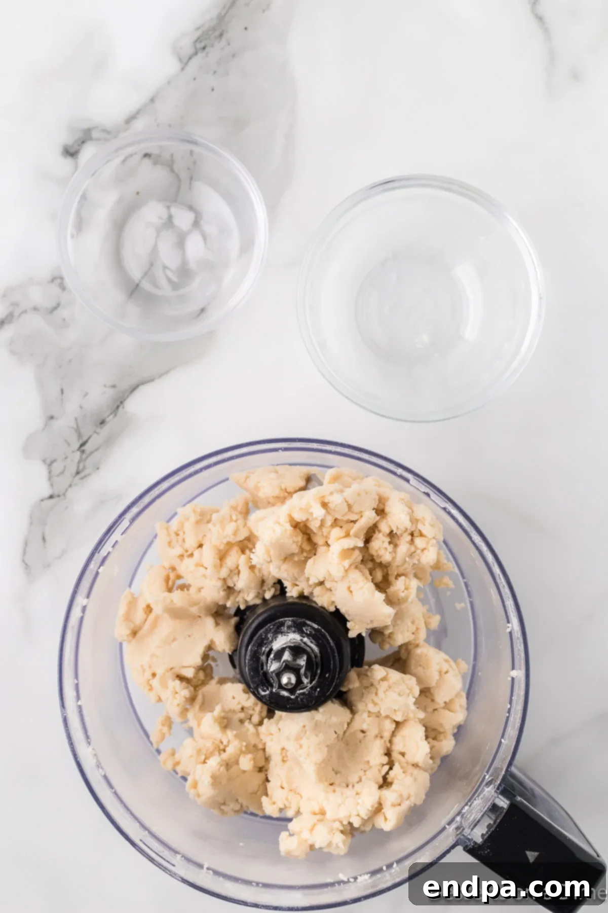 Water added to form dough mixture in food processor.