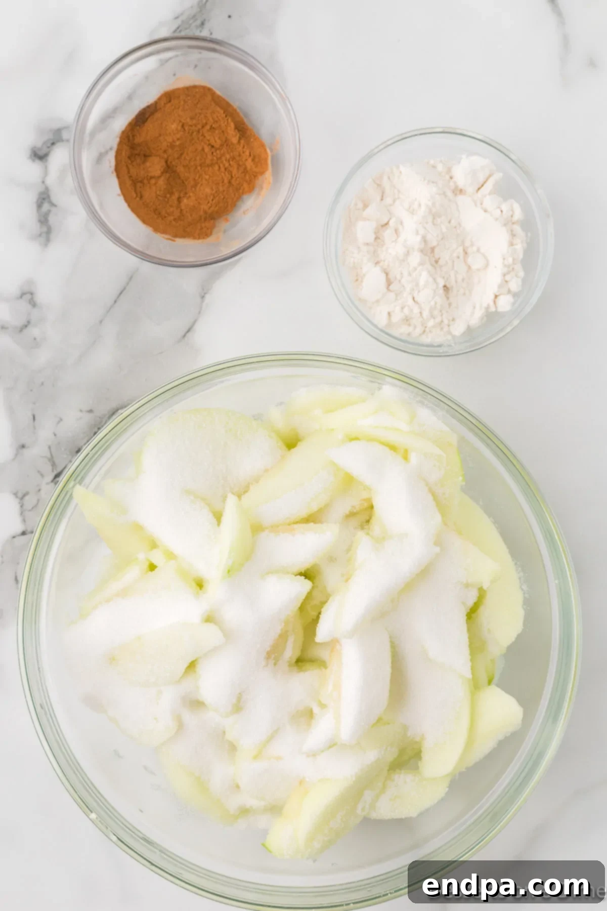 Apples in bowl with sugar.