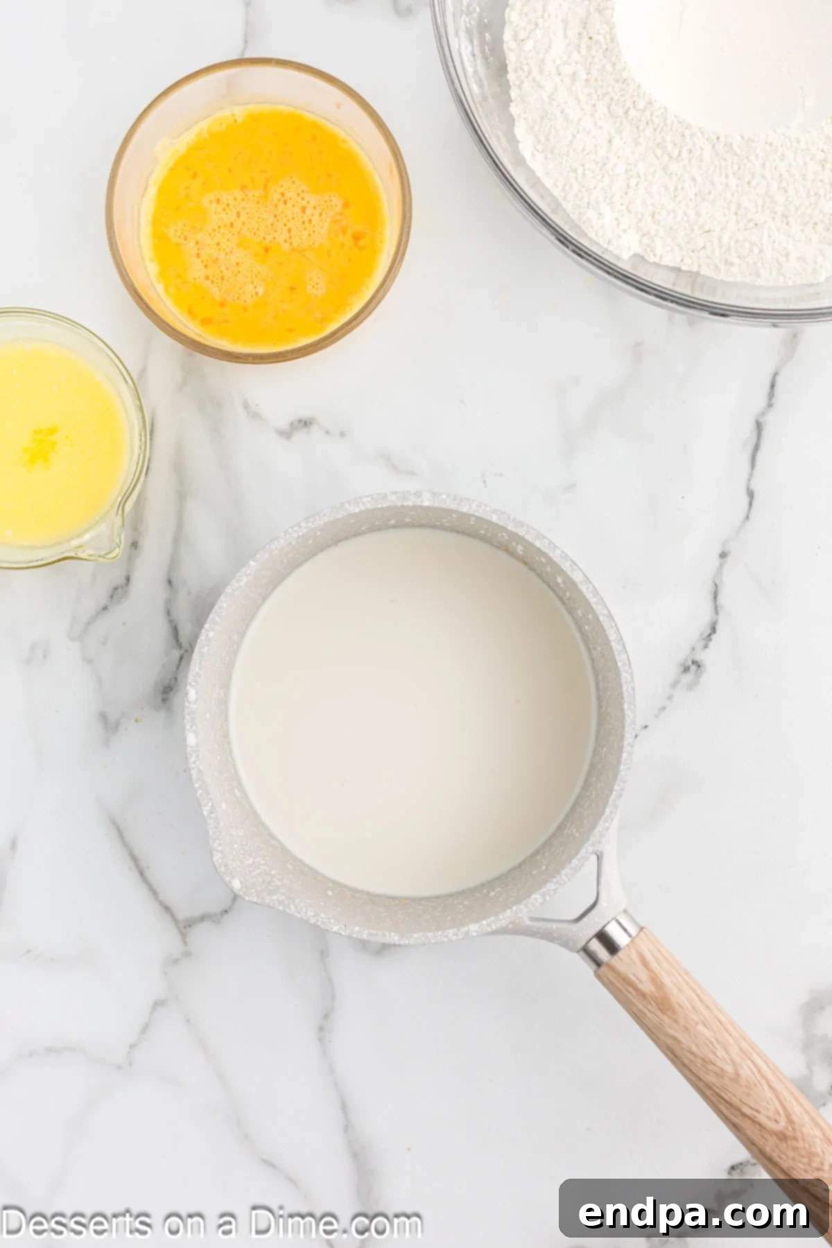 Milk being heated in a saucepan to the correct temperature.