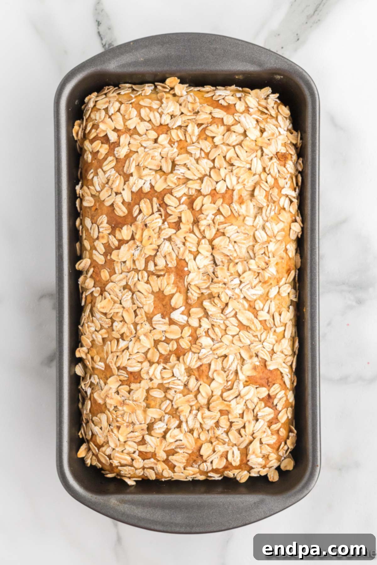 Baked oatmeal bread cooling on a wire rack.