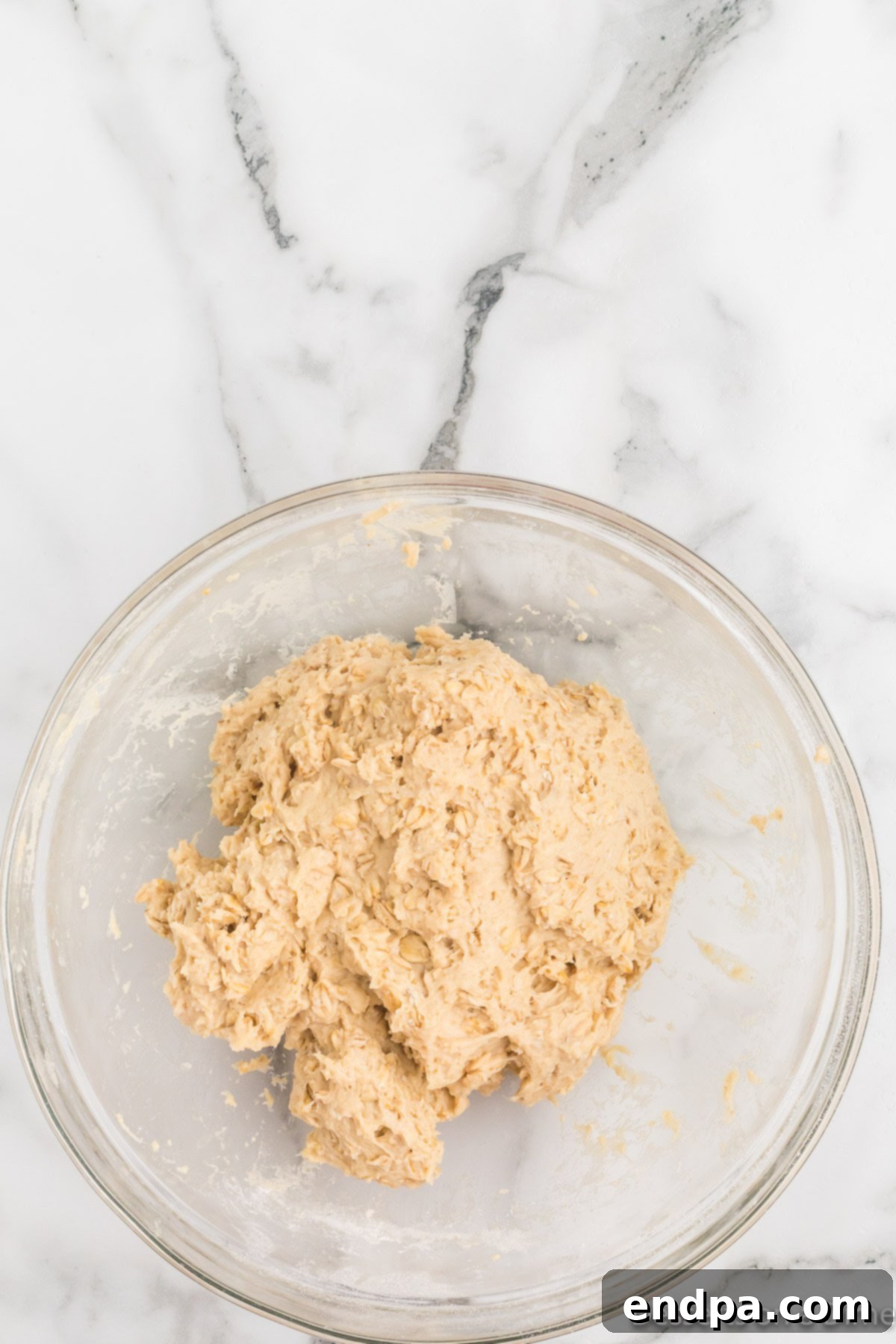 Kneaded bread dough in a greased bowl.