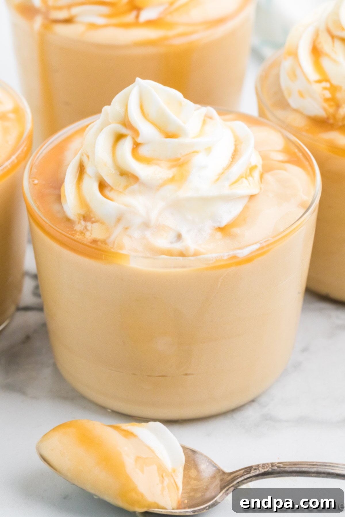 Pudding in cups topped with whipped cream.