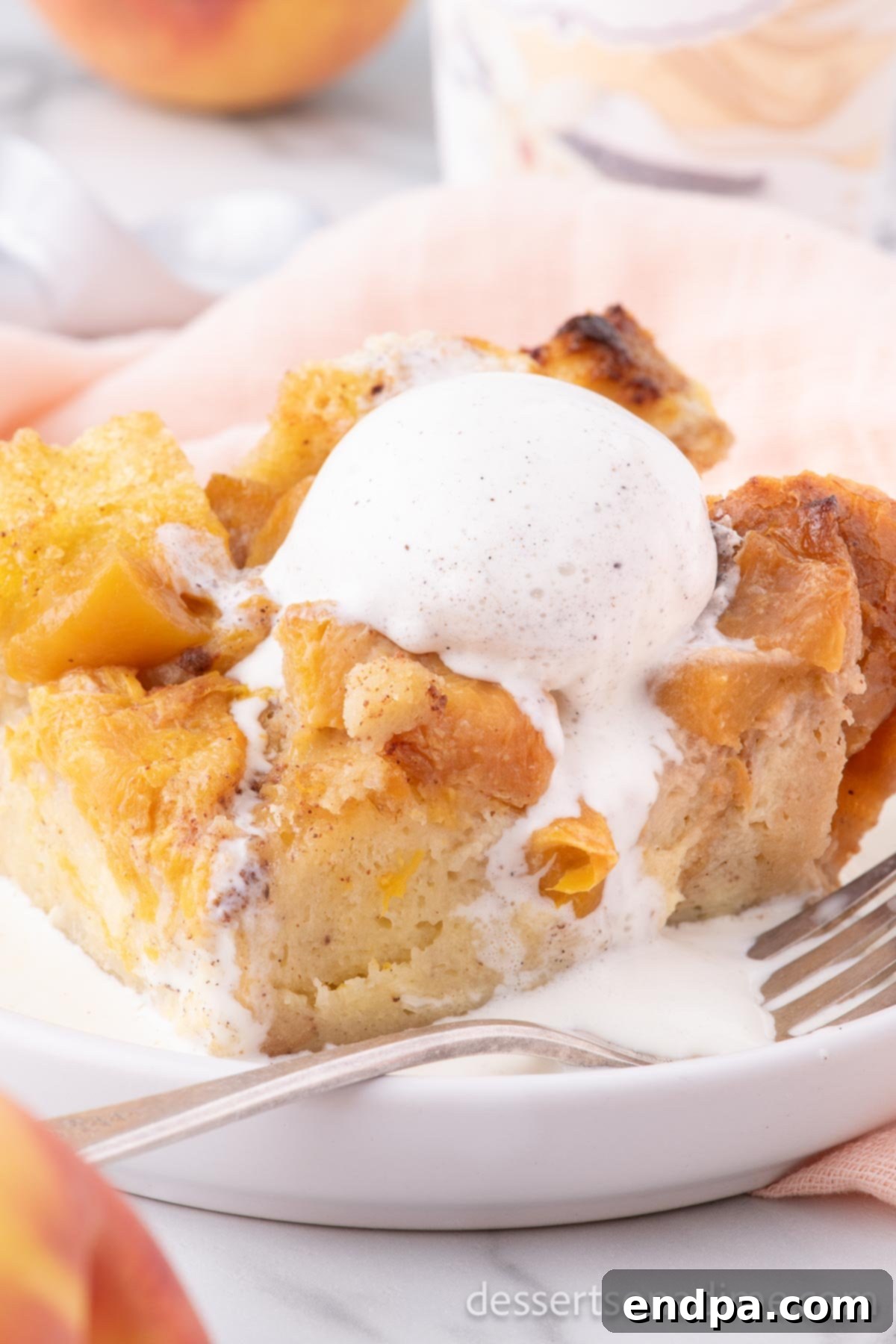 Summer Peach Bread Delight 2 Warm peach bread pudding topped with melting vanilla ice cream and a caramel drizzle, served in a rustic dish.