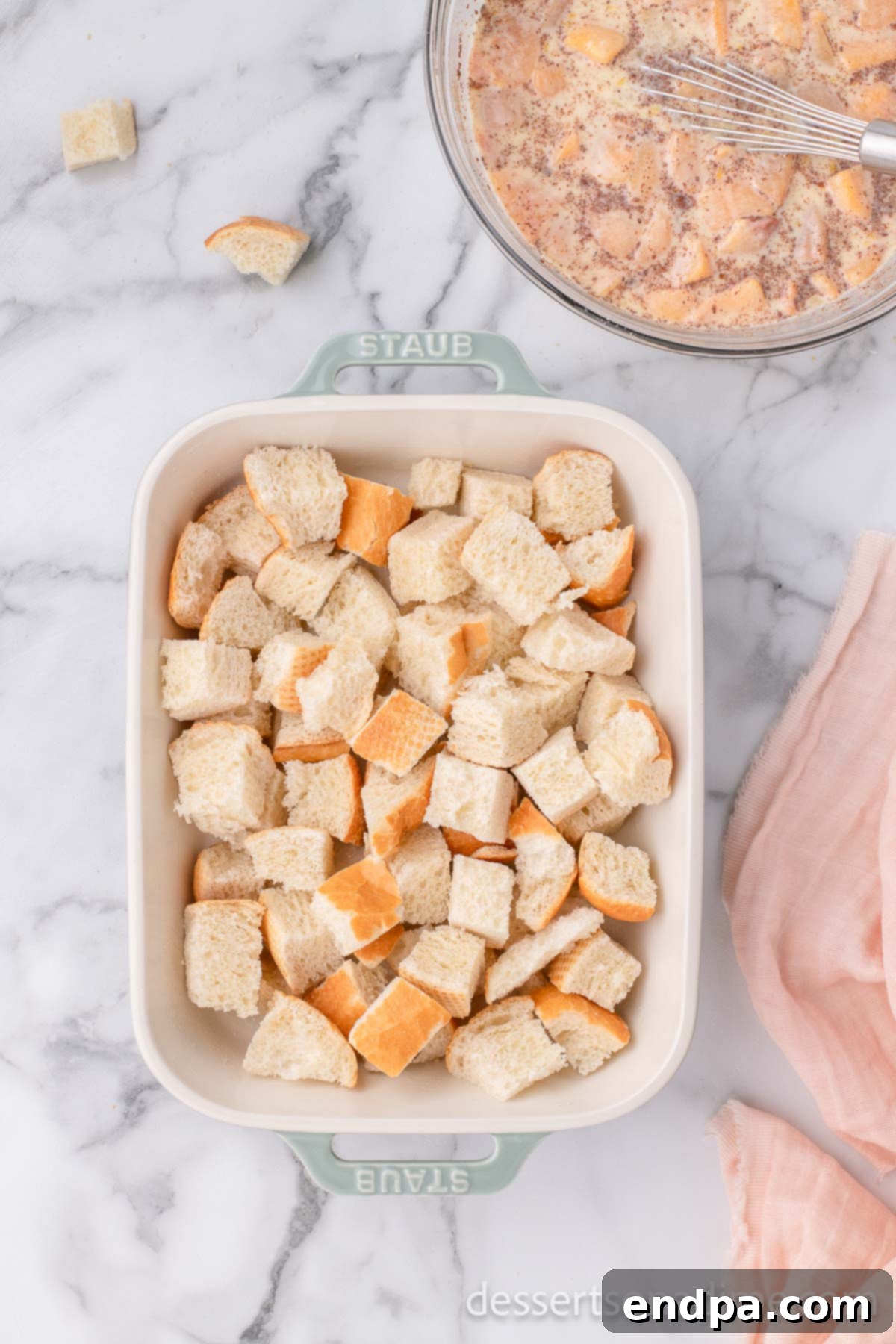 Summer Peach Bread Delight 5 Cubed stale bread evenly distributed in a prepared casserole dish.