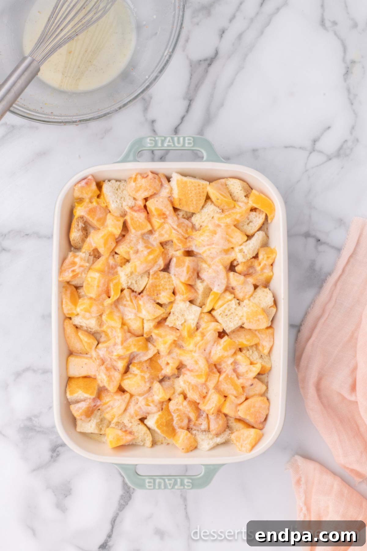 Summer Peach Bread Delight 8 The peach and custard mixture being poured over the bread cubes in the baking dish, ready for soaking.