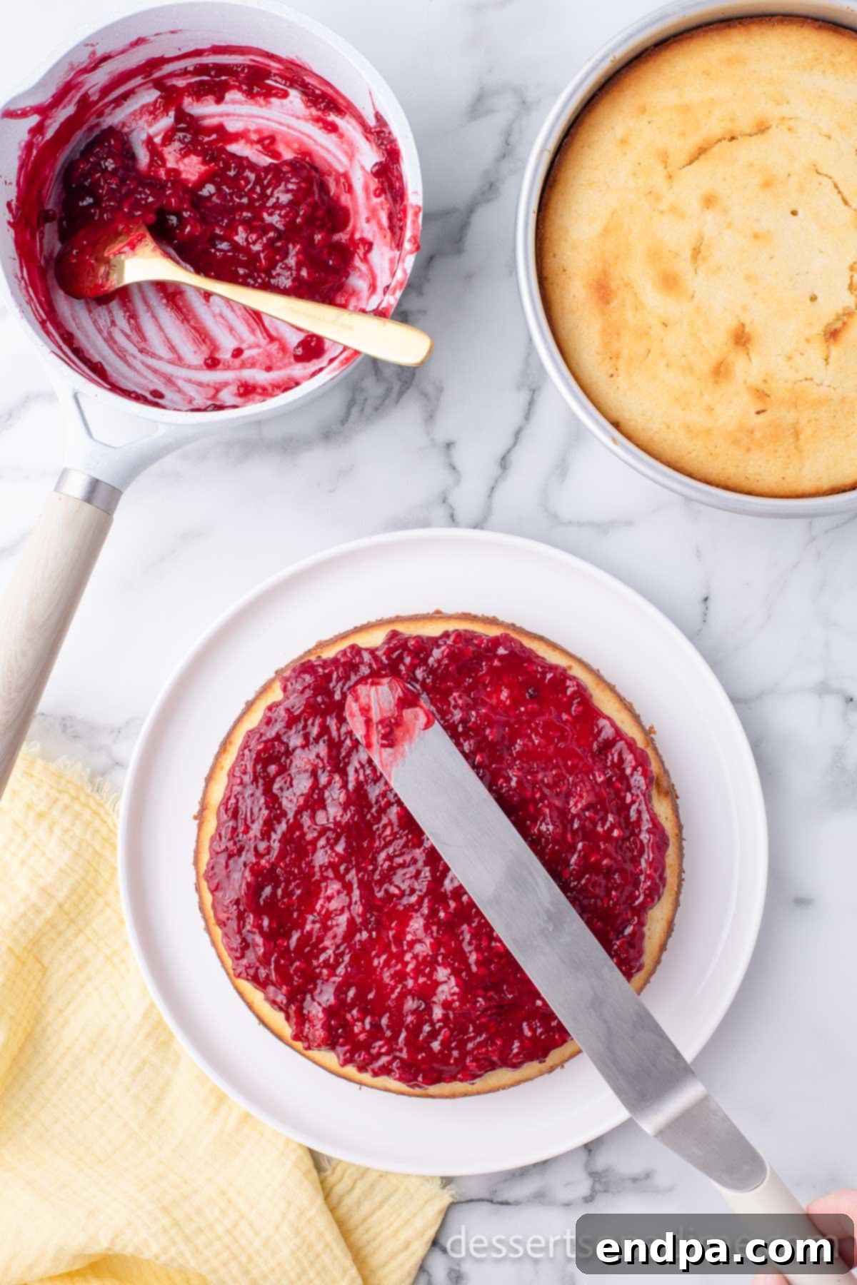 Luscious Lemon Blackberry Cake 12 Assembled cake layers with a generous spread of blackberry filling between them.