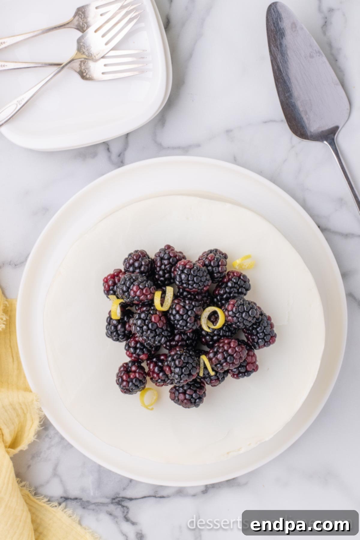Luscious Lemon Blackberry Cake 14 Finished Lemon Blackberry Cake garnished with fresh blackberries and lemon slices on top.