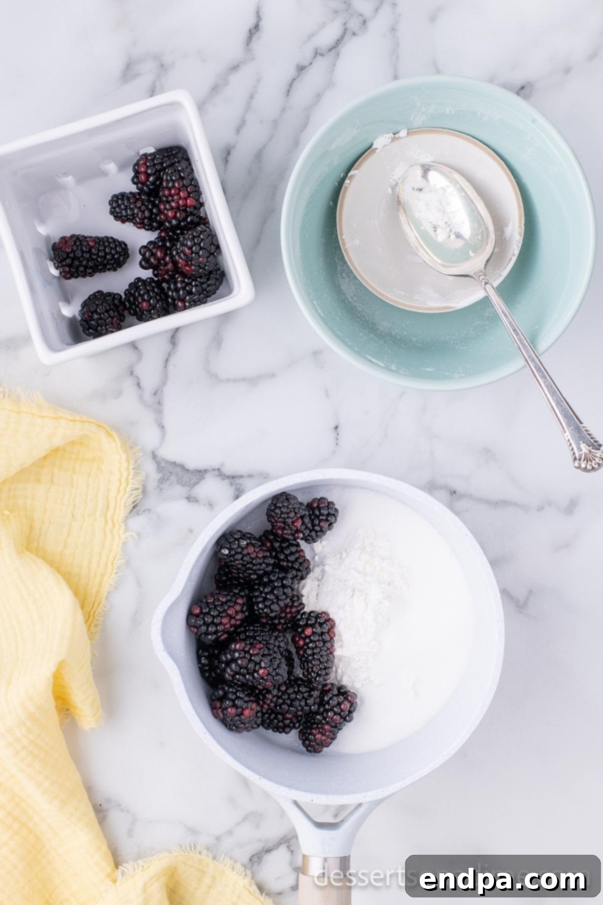 Luscious Lemon Blackberry Cake 8 A saucepan filled with fresh blackberries, granulated sugar, and cornstarch, ready to be cooked for the filling.