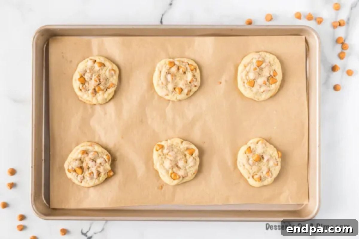 Chewy Butterscotch Cookies 5 Baked butterscotch cookies on a baking sheet, golden brown and perfectly cooked.