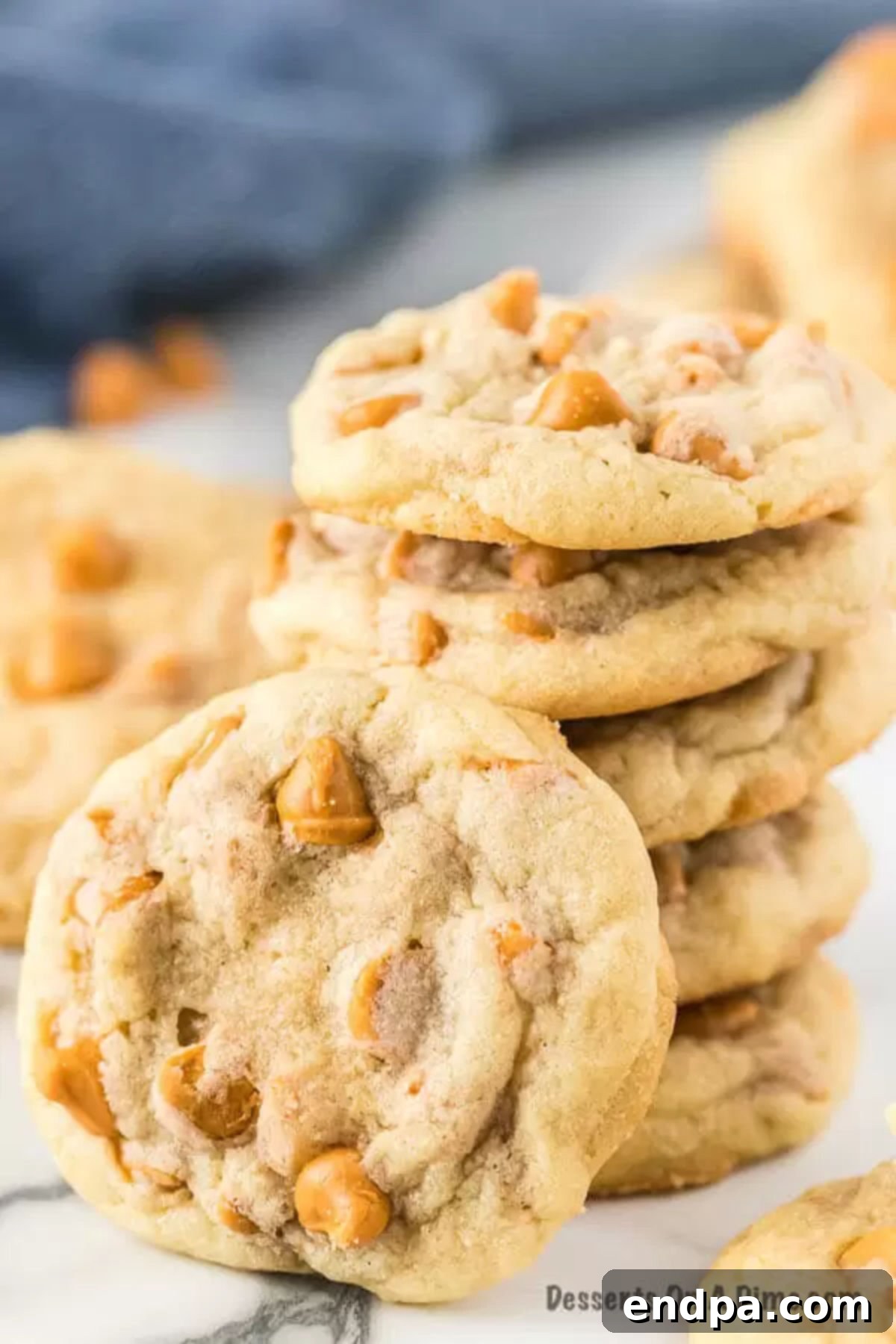 Perfectly baked butterscotch cookies, a delightful treat for any time of year. More stacked butterscotch cookies, showcasing their golden brown edges and chewy interior.