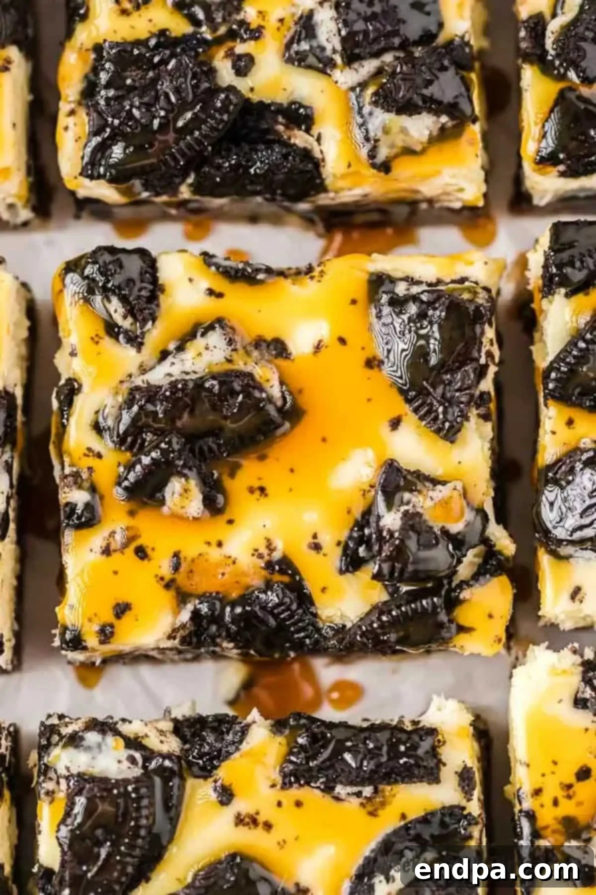 Ultimate Decadence Cheesecake Bars 2 Slutty Oreo Cheesecake bars, freshly baked and cut into perfect squares, stacked enticingly