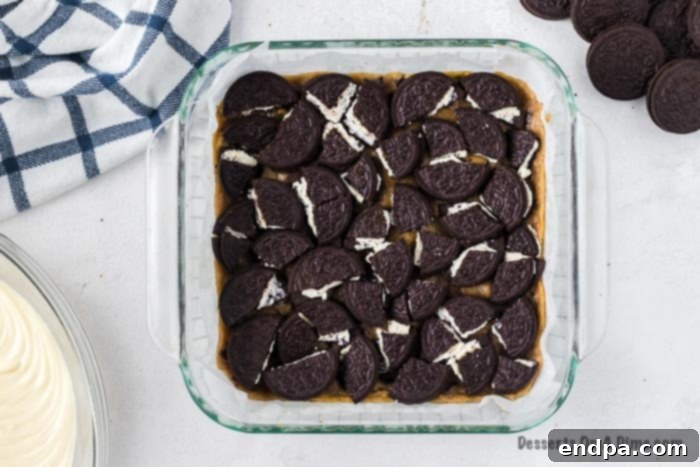 Ultimate Decadence Cheesecake Bars 6 A single layer of Oreo cookies carefully placed on top of the baked cookie dough crust.