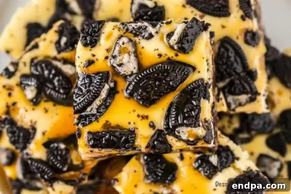 Ultimate Decadence Cheesecake Bars 8 Baked Slutty Cheesecake Bars, cut into squares and neatly stacked, showcasing their distinct layers.