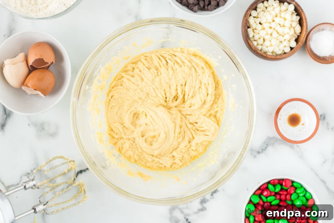 Joyful Christmas Cookie Bars 2 Dry ingredients combined in a bowl with wet ingredients, demonstrating the mixing process.