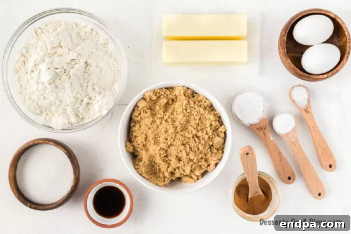 Close-up of brown sugar cookie ingredients: butter, light brown sugar, eggs, all-purpose flour, baking soda, cornstarch, salt, ground cinnamon, vanilla extract, and granulated sugar.