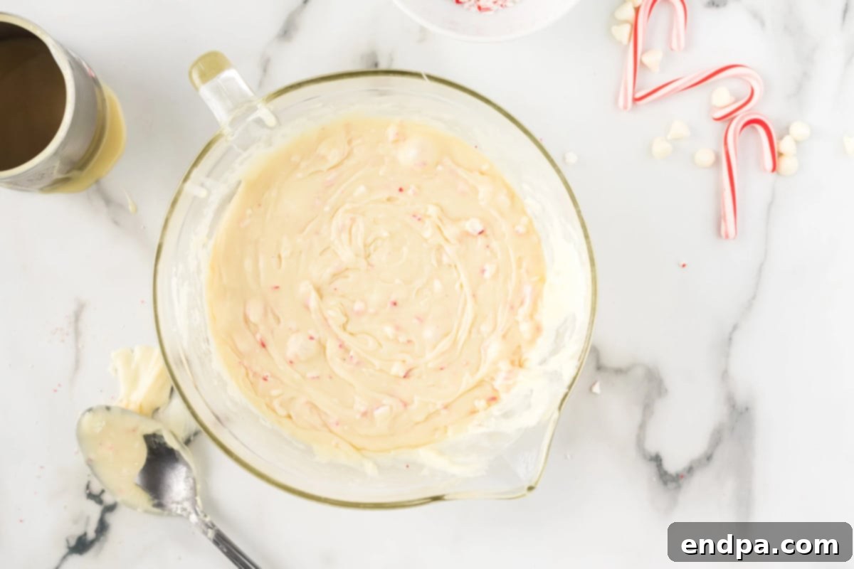 Peppermint candy pieces mixed into the melted chocolate and condensed milk mixture.