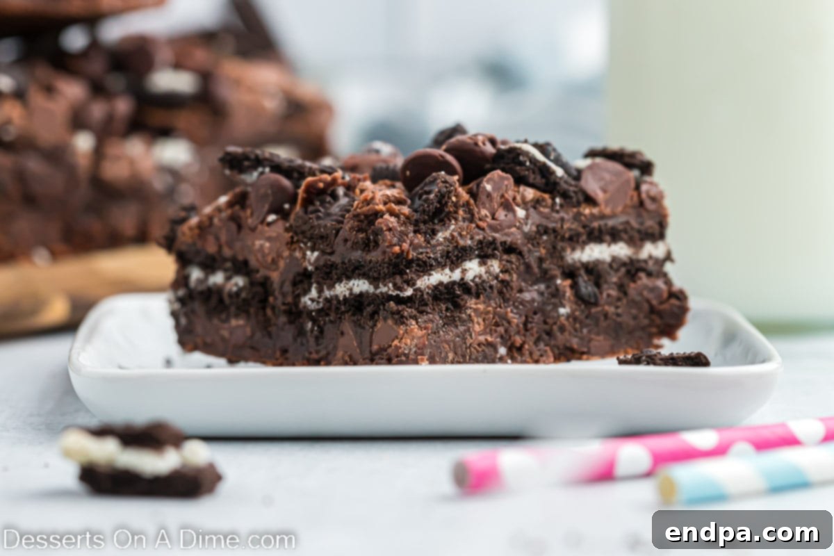 Oreo Brownie cut into bars and served on a white plate, showcasing its fudgy interior and cookie chunks.