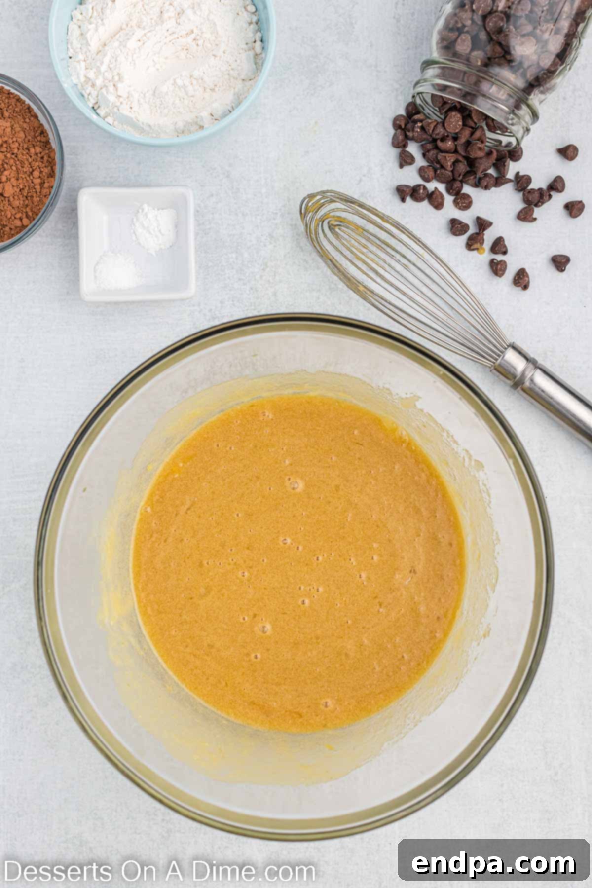 Butter, granulated sugar, and brown sugar mixture combined in a bowl.