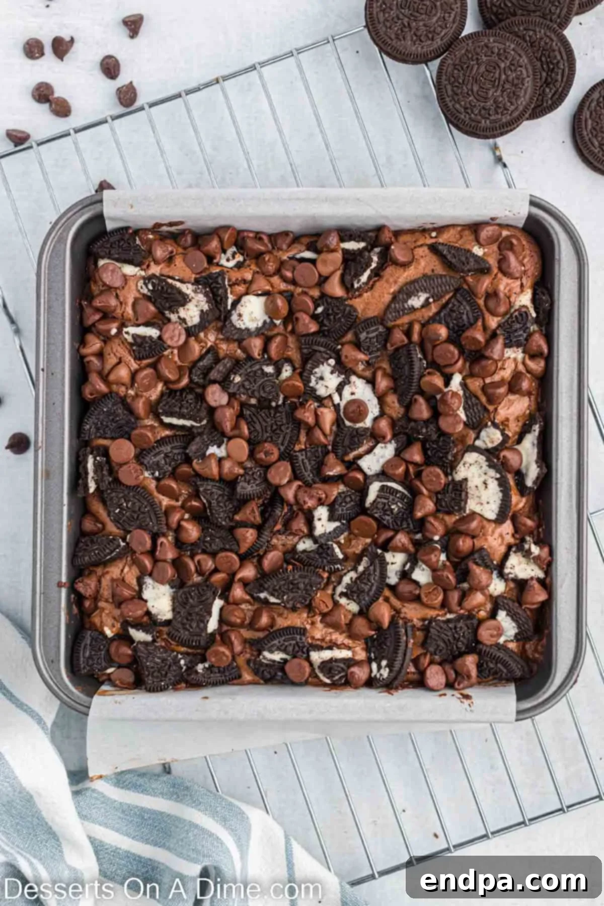 Baked Oreo brownies cooling in the pan on a wire rack.