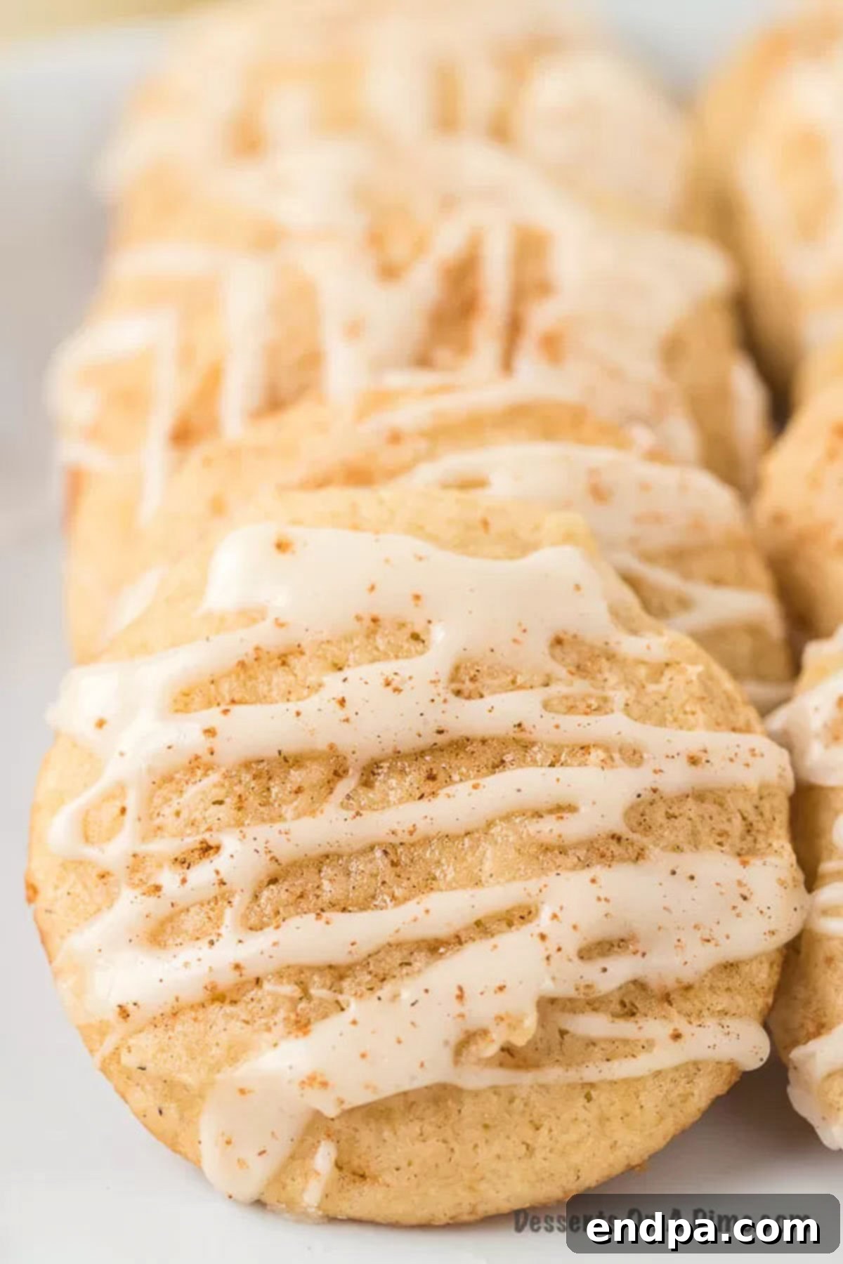 Eggnog cookies stacked together, showcasing their soft texture and delightful frosting, perfect for holiday gatherings.
