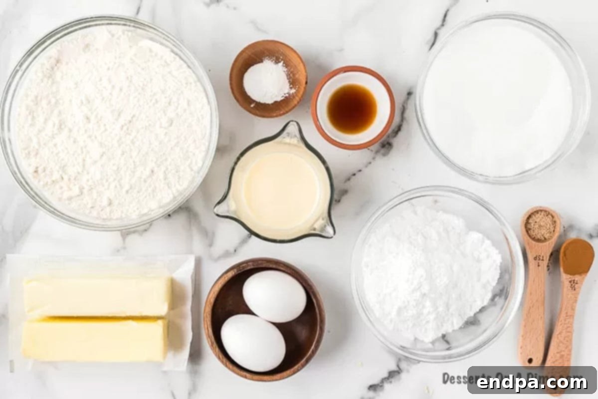 Ingredients needed for eggnog cookies: butter, white sugar, eggs, flour, baking powder, nutmeg, cinnamon, eggnog, vanilla extract, and powdered sugar for the frosting.