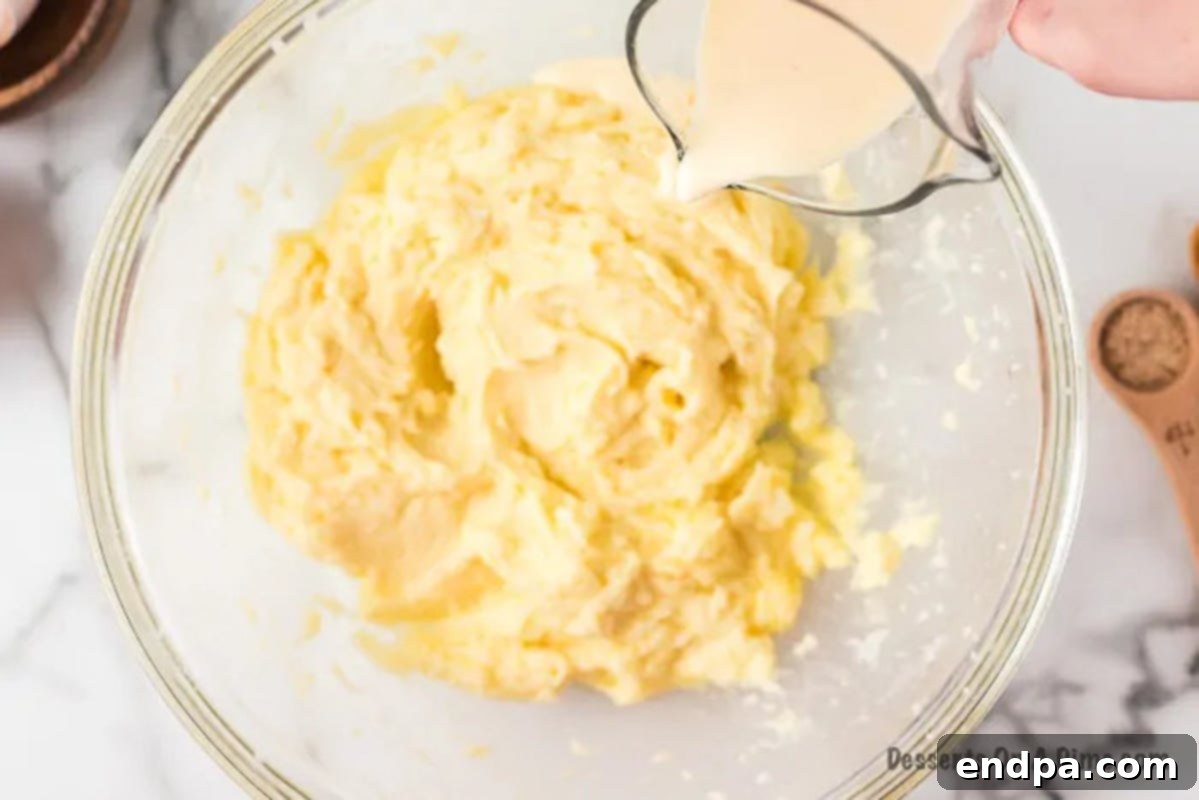 Eggnog being poured into the wet mixture.