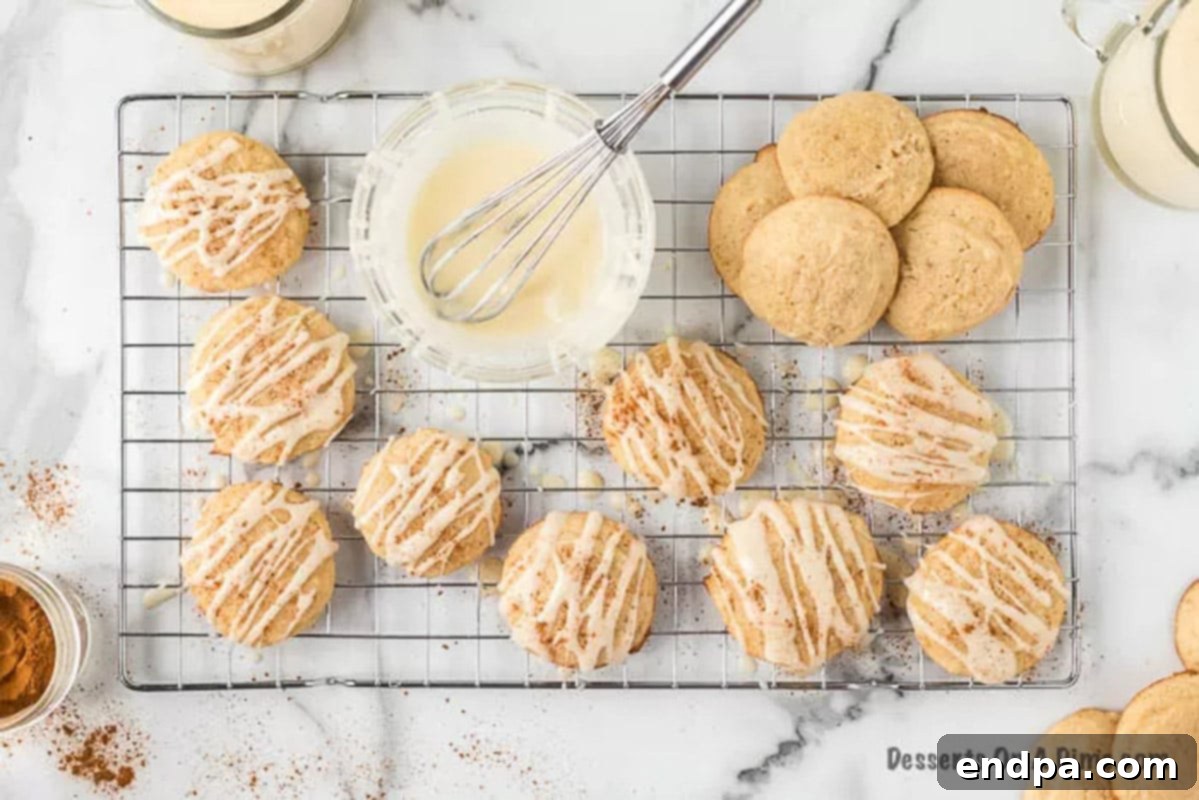 Freshly baked eggnog cookies cooling on a wire rack.