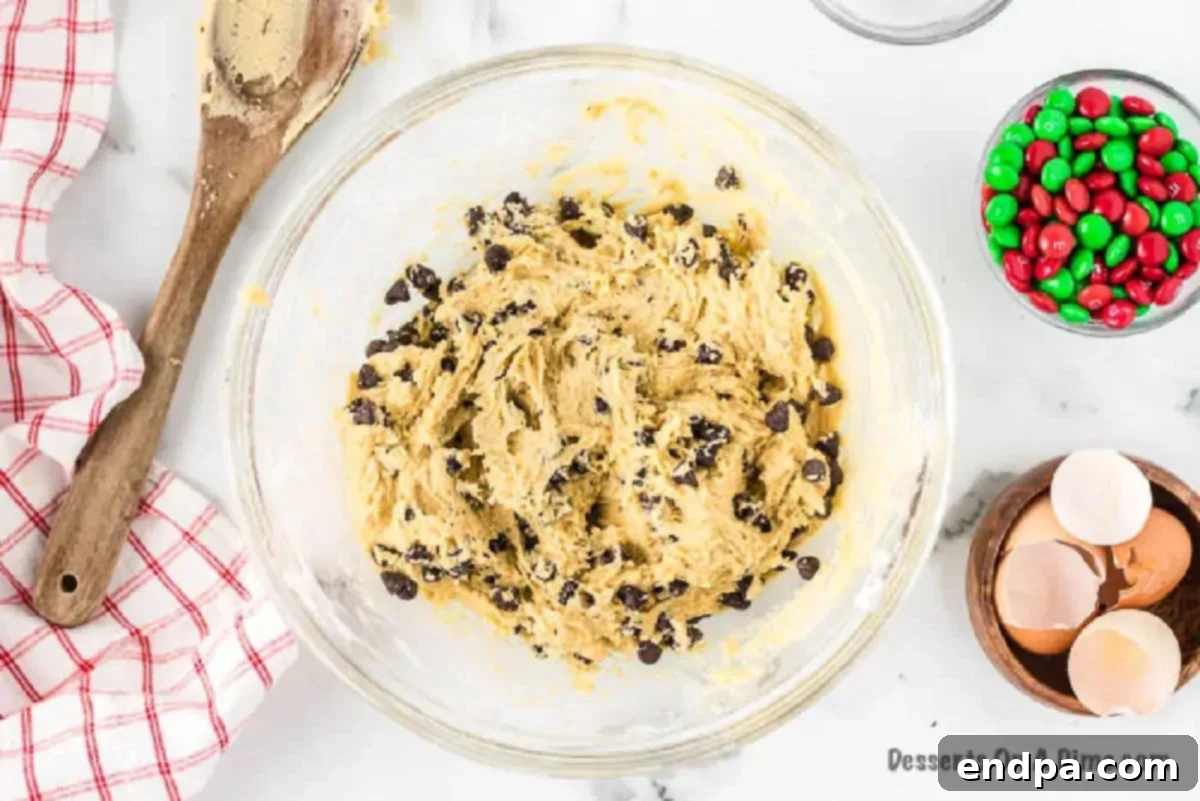 Deliciously Simple Santa Cookies 3 Folding chocolate chips into the cookie dough mixture by hand